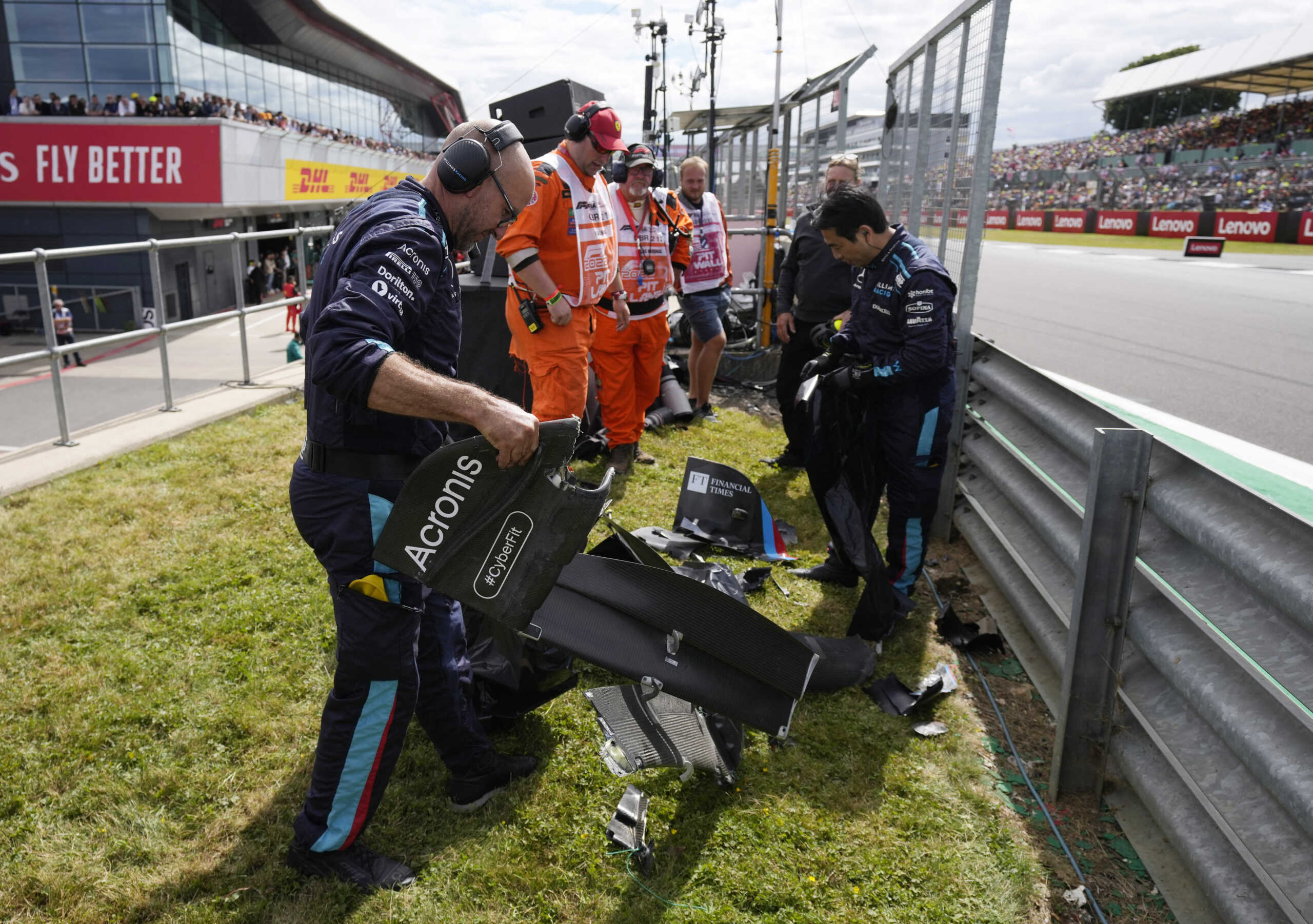 Formula One F1 - British Grand Prix - Silverstone Circuit, Silverstone, Britain - July 3, 2022 Staff clear debris after Alfa Romeo's Guanyu Zhou crashes out at the start of the race Pool via REUTERS