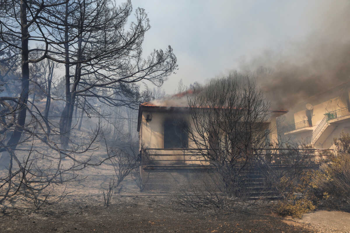 A house burns as a wildfire rages at the village of Vatera, on the island of Lesbos, Greece July 23, 2022. REUTERS