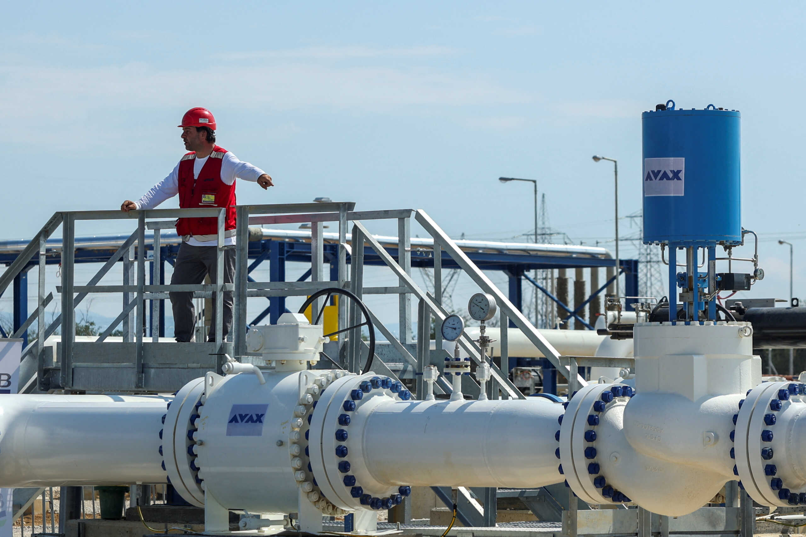A member of the staff stands over a part of the Interconnector Greece-Bulgaria (IGB) gas pipeline that will carry gas from Komotini to Stara Zagora in Bulgaria, in Komotini, Greece, July 8, 2022. REUTERS