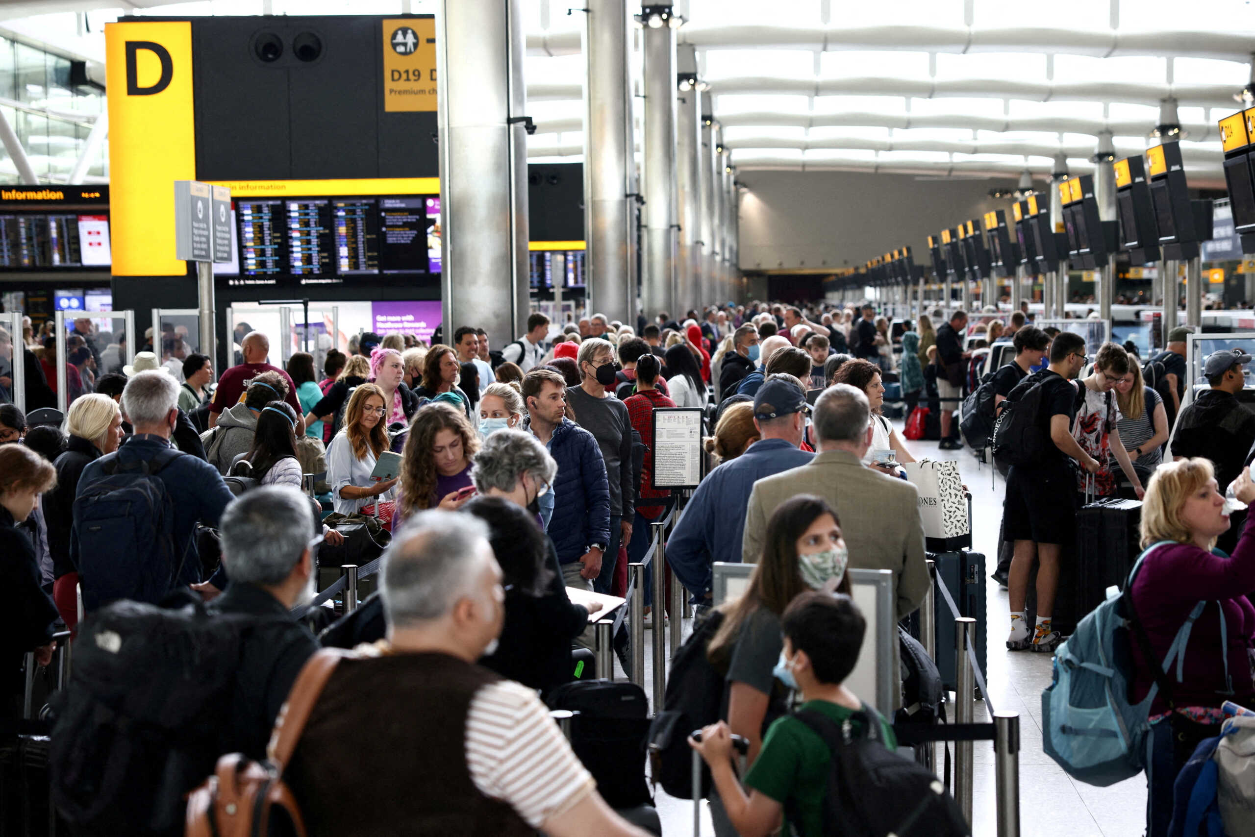 FILE PHOTO: Passengers queue inside the departures terminal of Terminal 2 at Heathrow Airport in London, Britain, June 27, 2022. REUTERS