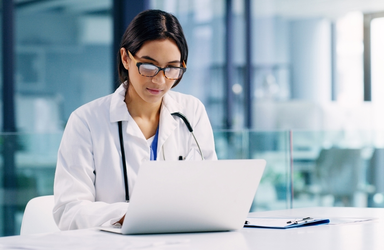 Shot of a young doctor using a laptop in a hospital