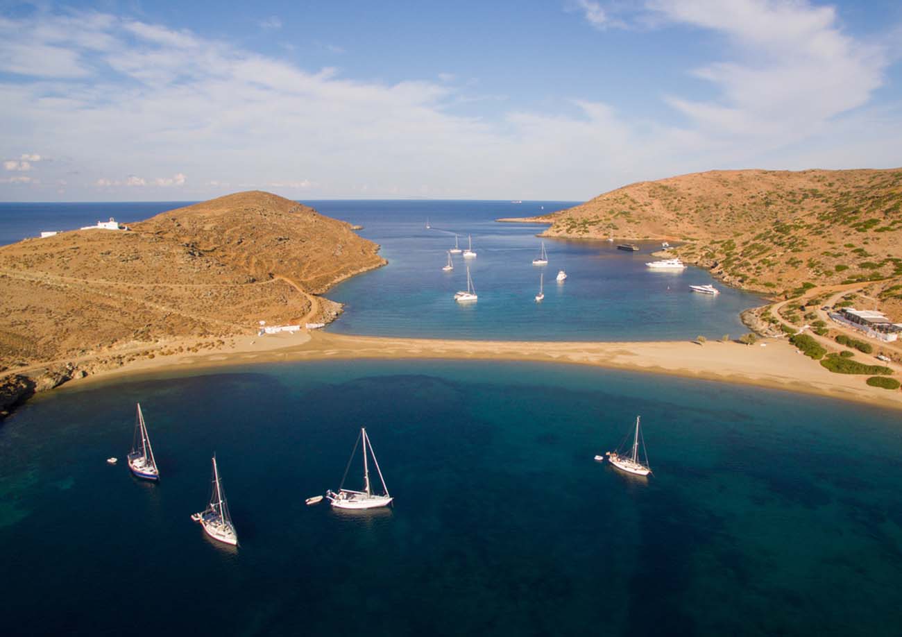 Group of sailboats moored at beautiful bay on amazing Colona beach on Kythnos island at Cyclades, Greece