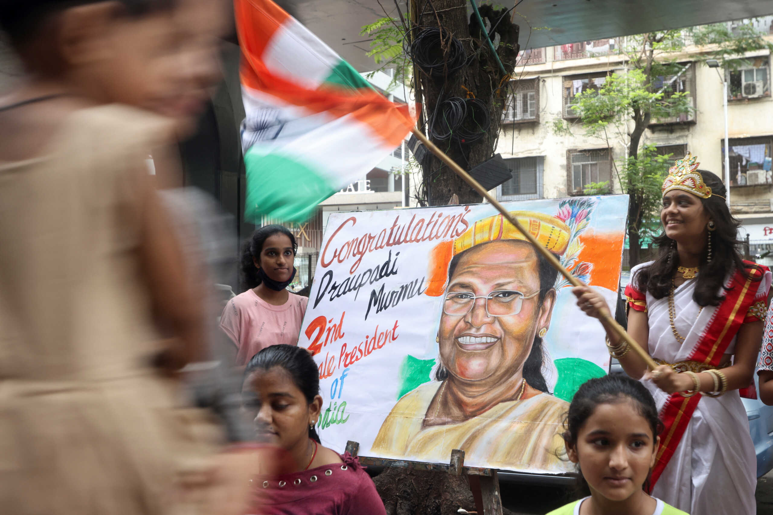 Students of an art school pose with paintings of Draupadi Murmu, a female politician from a tribal community who is nominated as presidential candidate by Prime Minister Narendra Modi's ruling Bharatiya Janata Party (BJP), on a street in Mumbai, India, July 21, 2022. REUTERS