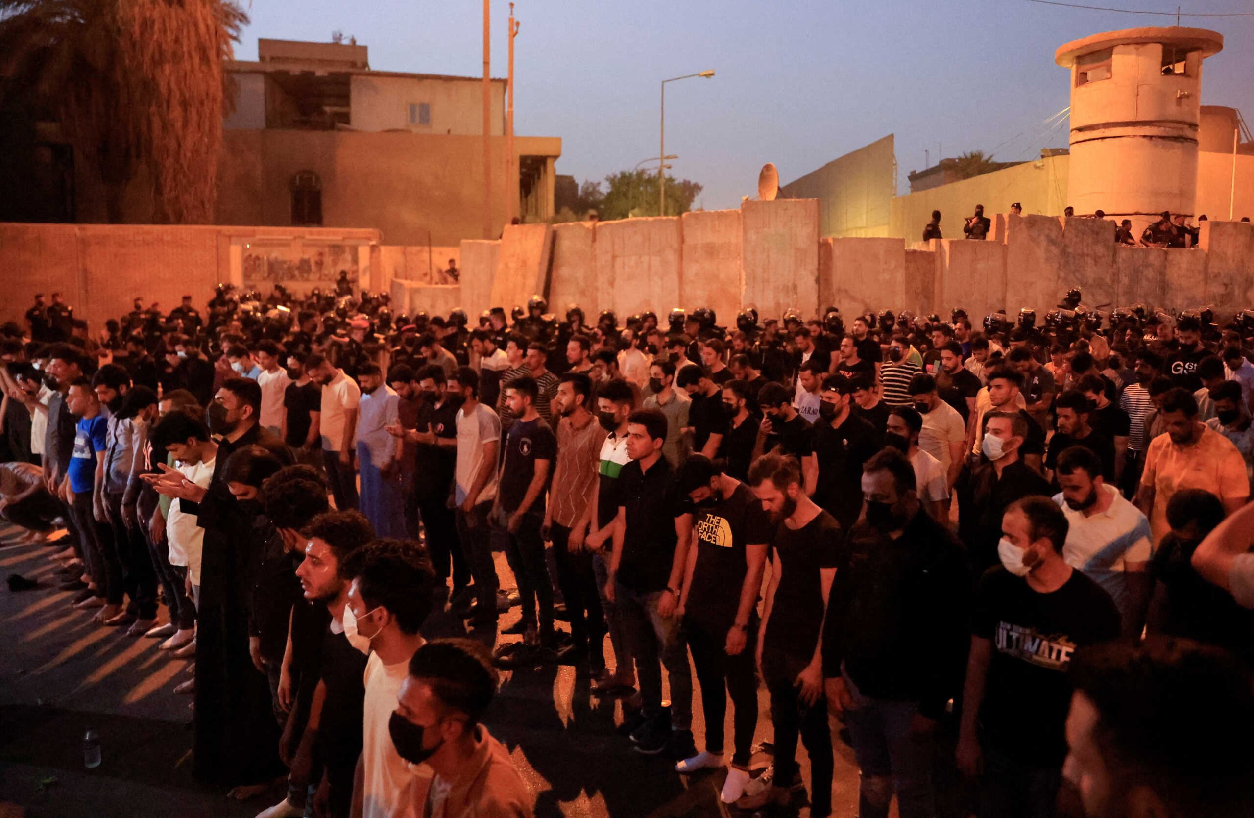 Protesters pray near the old Turkish embassy building during a demonstration against an attack on a mountain resort in Iraq's northern province of Dohuk, in Baghdad, Iraq July 21, 2022. REUTERS