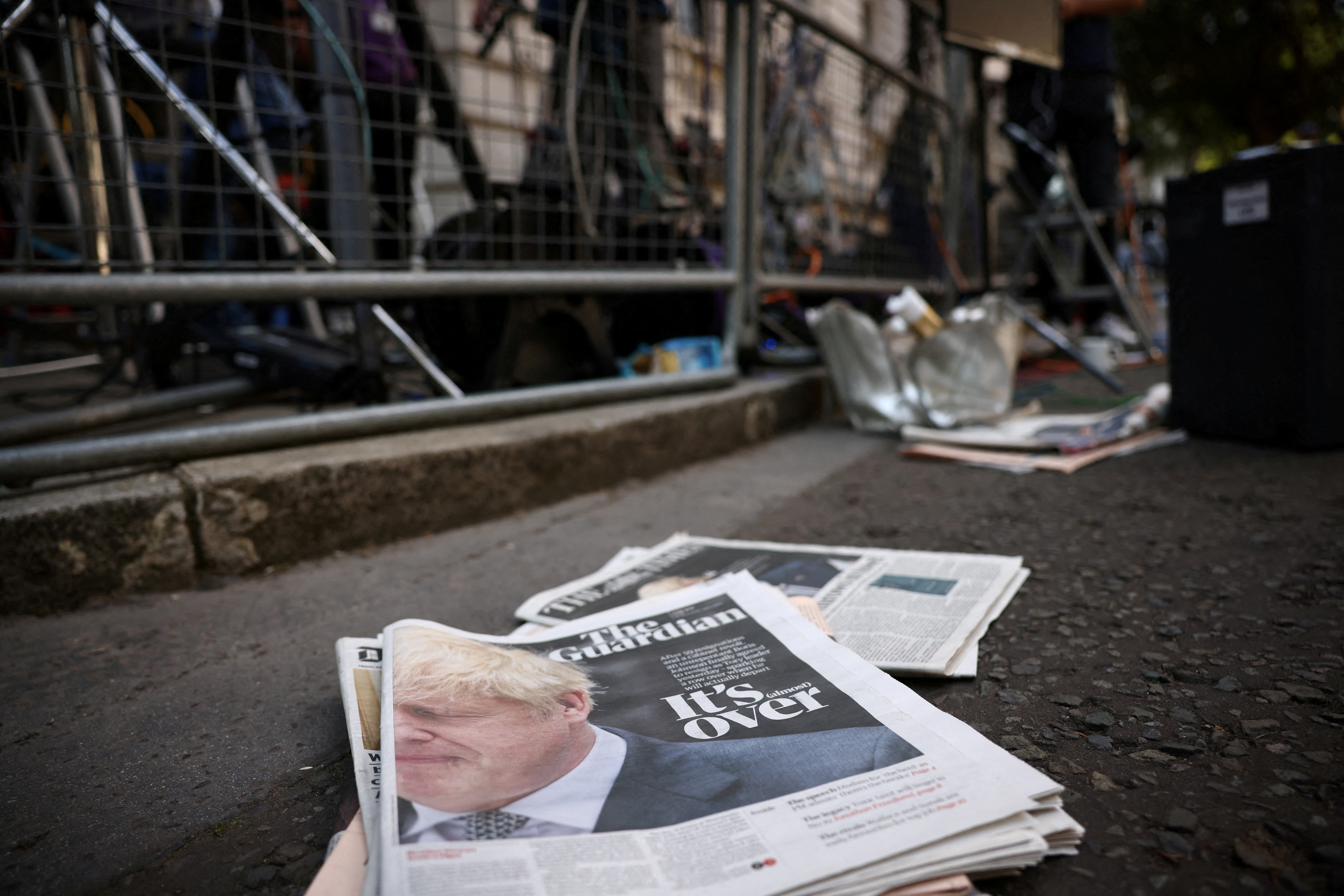 FILE PHOTO: Newspapers reporting the resignation of Boris Johnson lay on the floor at Downing Street in London, Britain, July 8, 2022. REUTERS