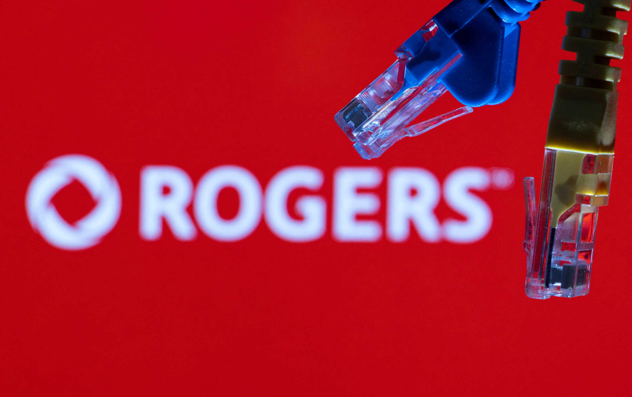 FILE PHOTO: Ethernet cables are seen in front of Rogers Communications logo in this illustration taken, July 8, 2022. REUTERS