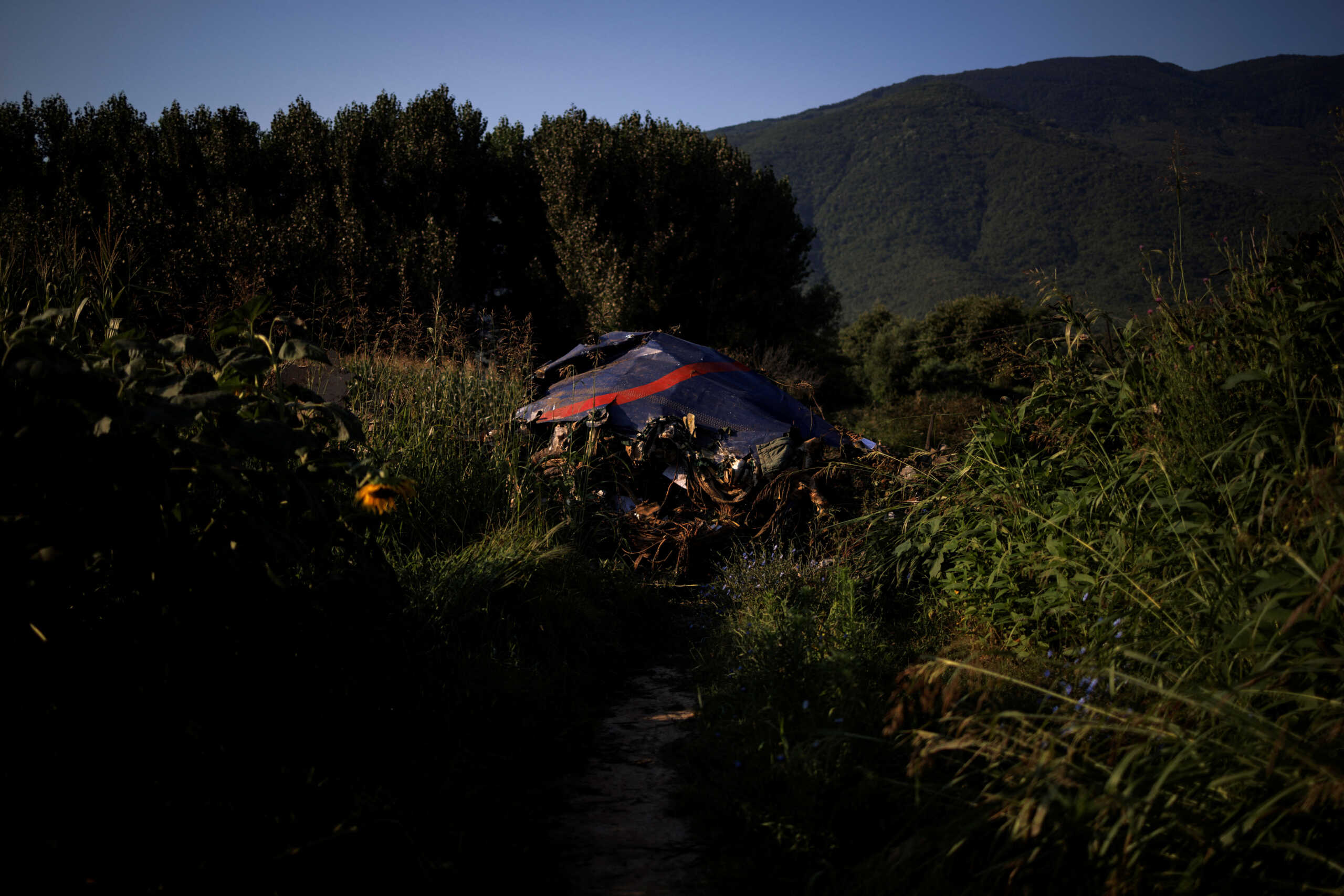 Debris is seen at the crash site of an Antonov An-12 cargo plane owned by a Ukrainian company, near Kavala, Greece, July 17, 2022. REUTERS