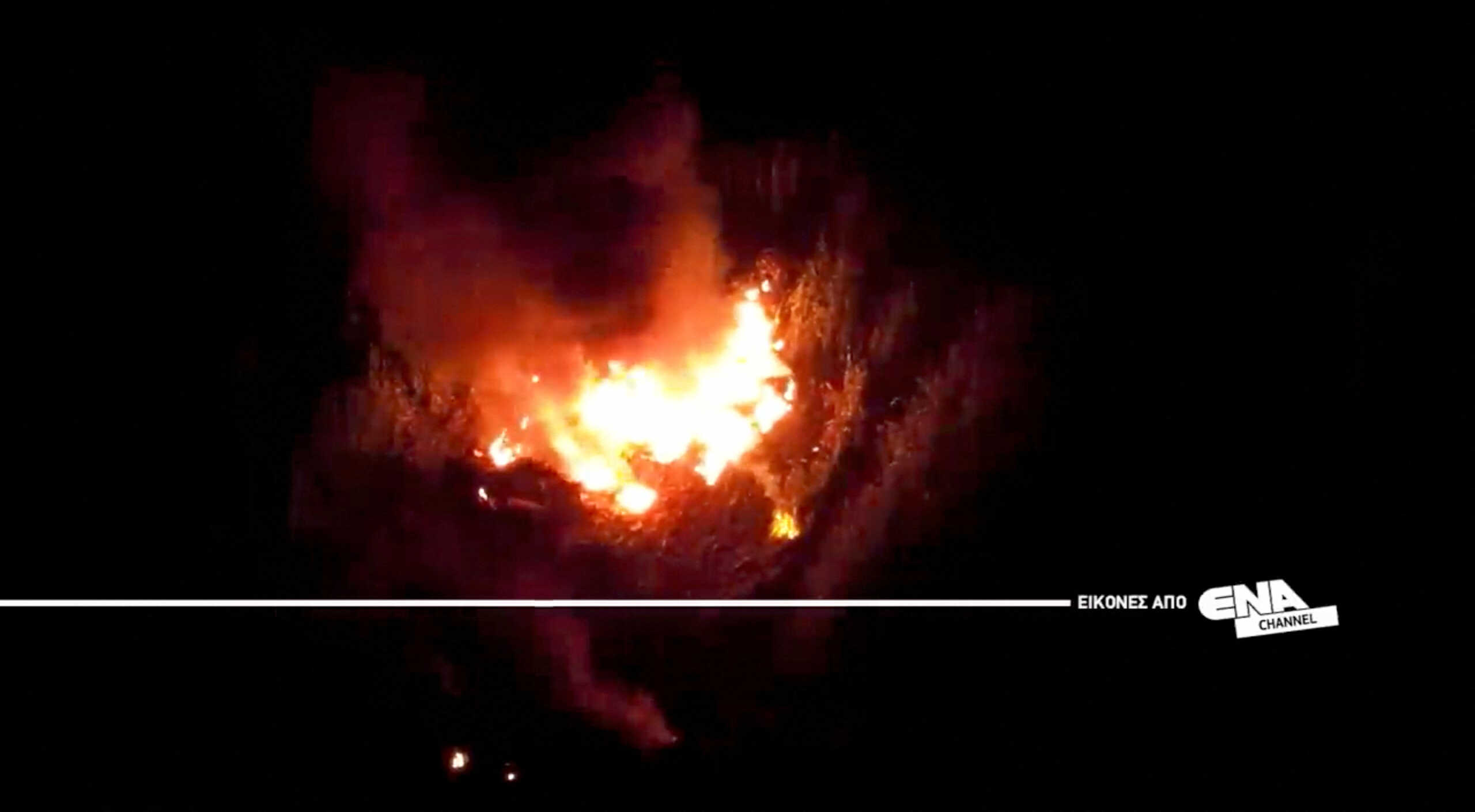 A drone view shows the burning debris at the crash site of an Antonov An-12 cargo plane owned by a Ukrainian company, near Kavala, Greece, July 16, 2022. ENA Channel