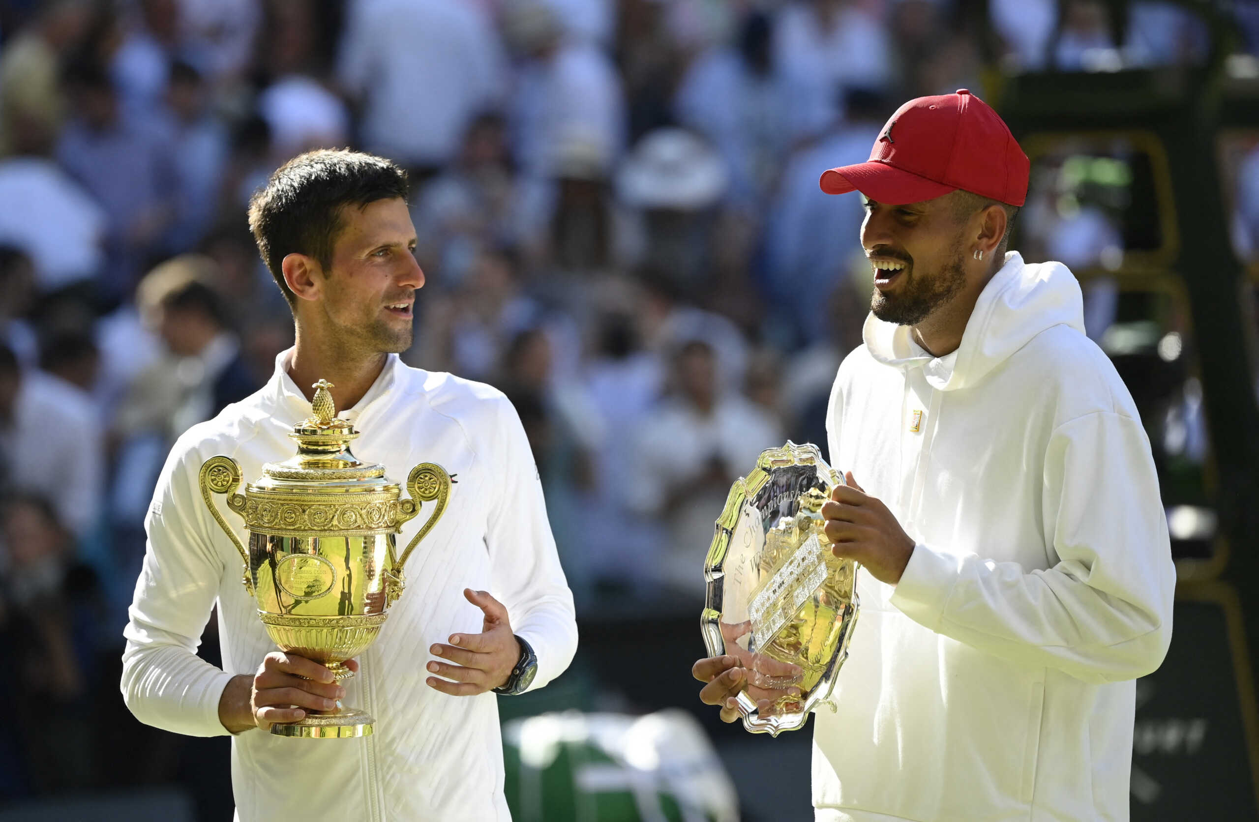 Tennis - Wimbledon - All England Lawn Tennis and Croquet Club, London, Britain - July 10, 2022 Serbia's Novak Djokovic poses with the trophy after winning the men's singles final alongside runner up Australia's Nick Kyrgios REUTERS