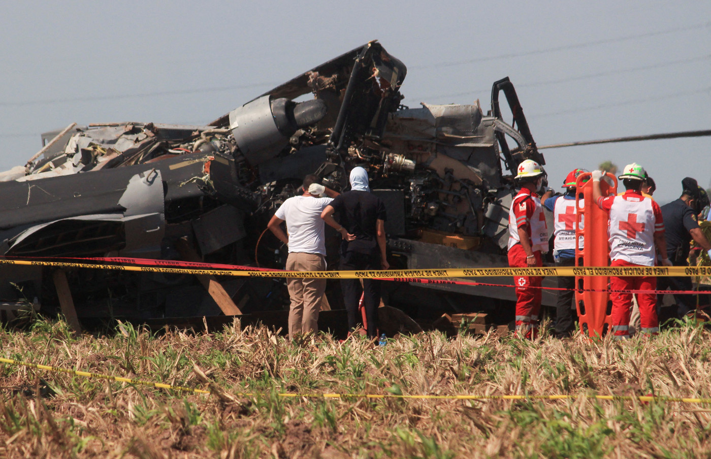 Red Cross paramedics stand next to the wreckage of a Black Hawk military helicopter that crashed in Los Mochis, in Sinaloa state, Mexico July 15, 2022. REUTERS