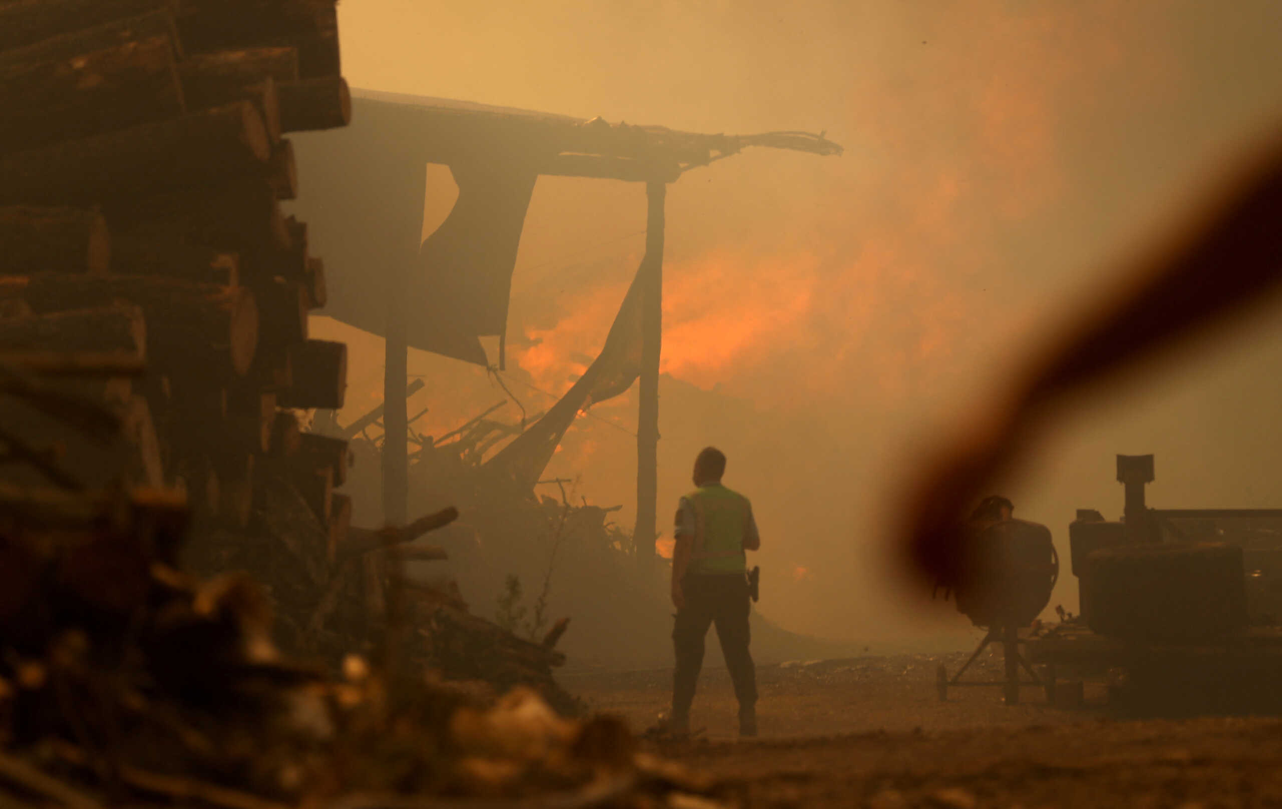 A person stands as a wildfire continues, in Leiria, Portugal July 13, 2022. REUTERS