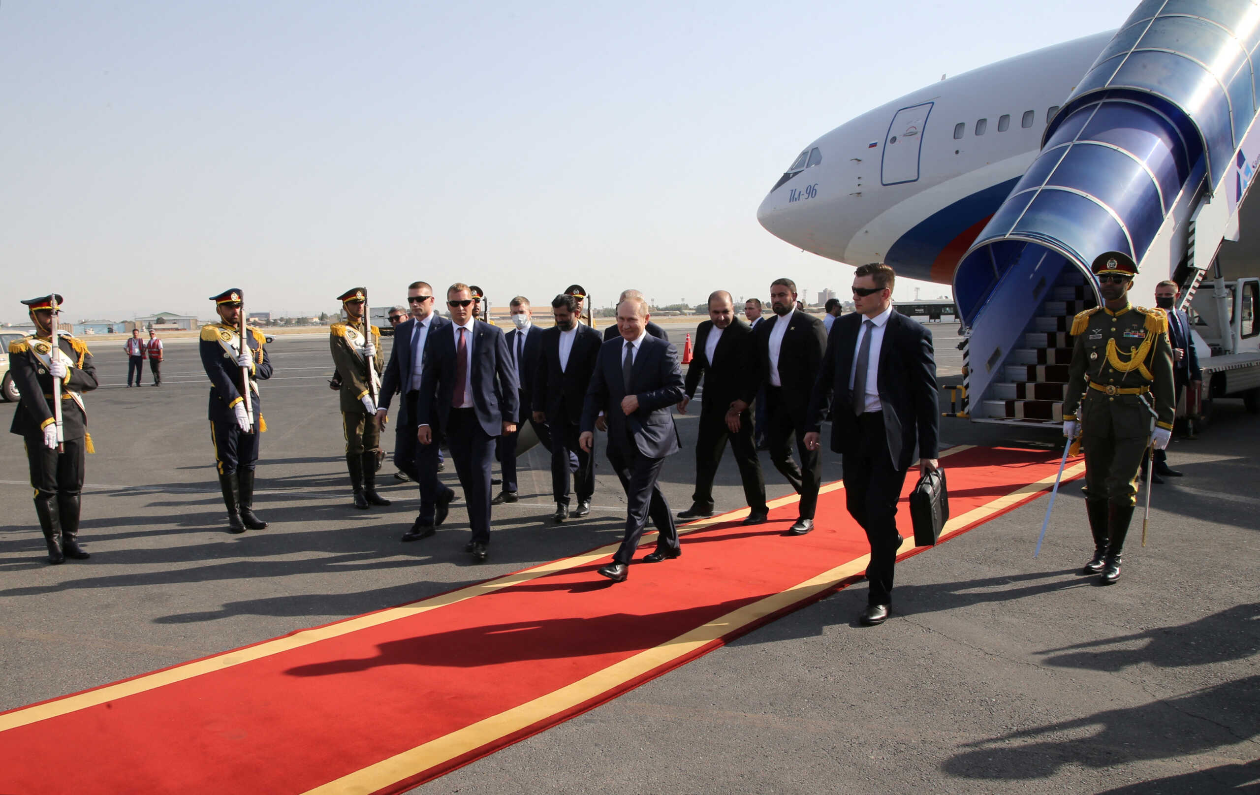 Russian President Vladimir Putin takes part in a welcoming ceremony at an airport upon his arrival in Tehran, Iran July 19, 2022. Sputnik