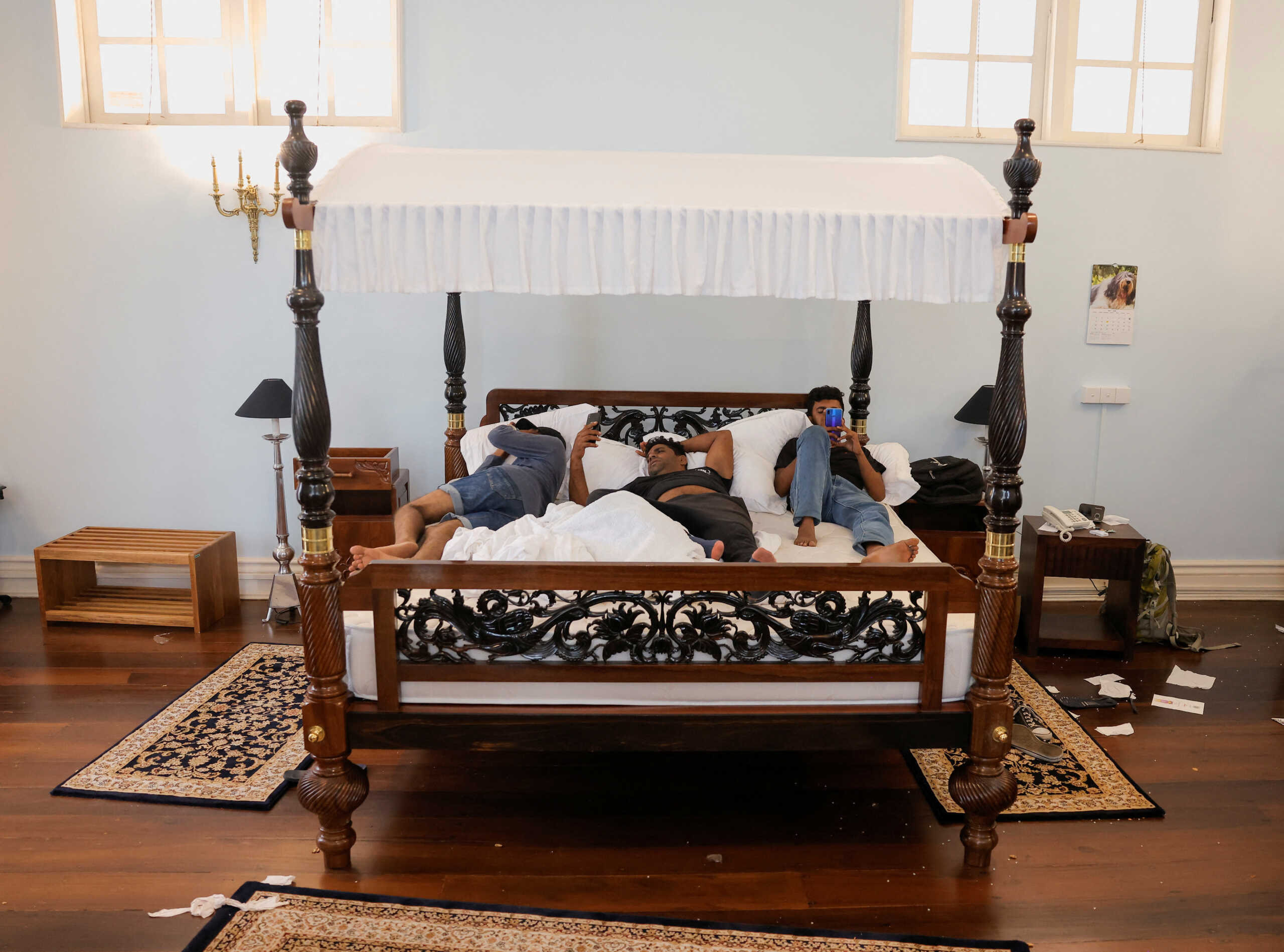 Demonstrators sleep on the President Gotabaya Rajapaksa's bed at the President's house, on the following day after demonstrators entered the building, after President Gotabaya Rajapaksa fled, amid the country's economic crisis, in Colombo, Sri Lanka July 10, 2022. REUTERS