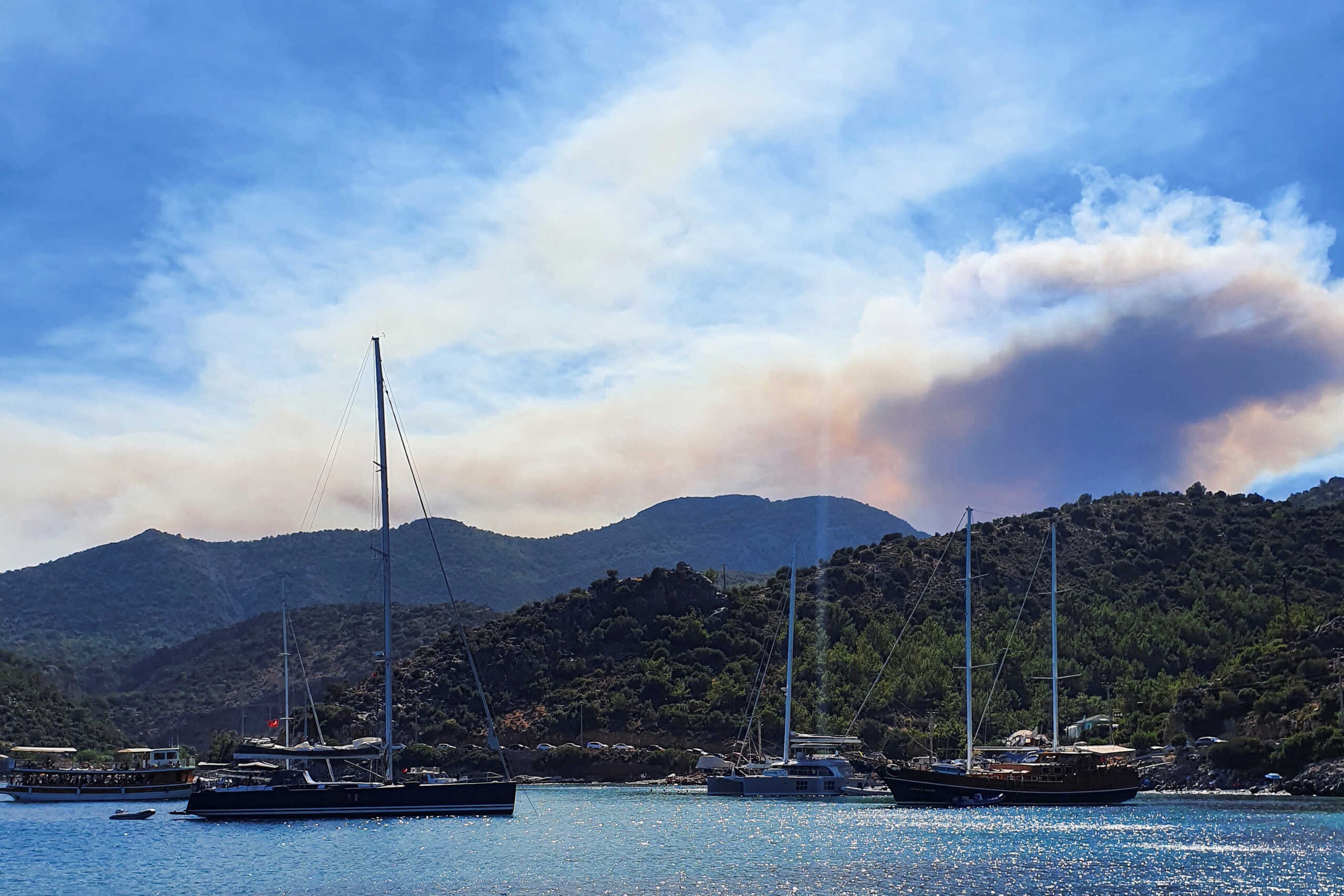 Smoke rises from a wildfire as it is seen from Kargi Bay in Datca in Mugla province, Turkey July 13, 2022. REUTERS
