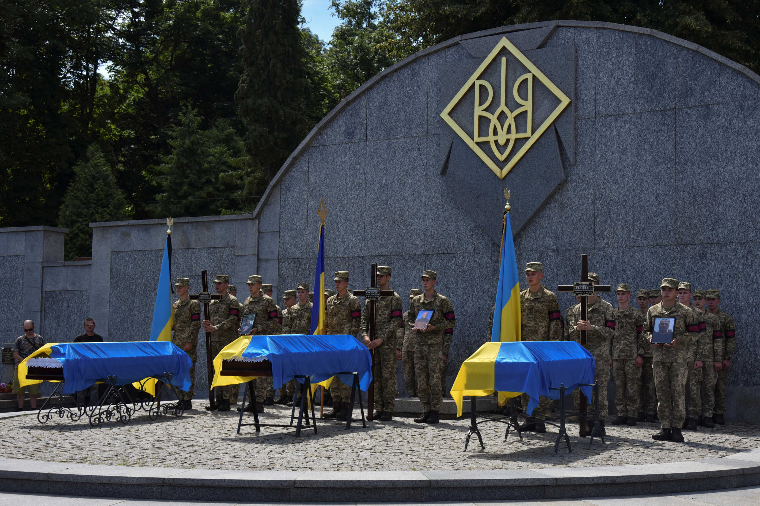 Ukrainian servicemen attend a funeral ceremony for their brothers-in-arms Volodymyr Hirniak, Serhii Kovalov and Mykola Zabavchuk, who were recently killed in a battle against Russian troops, as Russia's attack on Ukraine continues, in Lviv, Ukraine July 26, 2022.  REUTERS