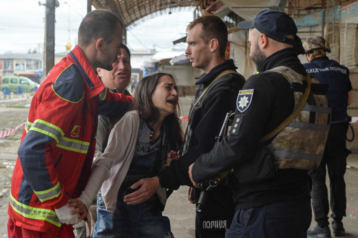 A woman reacts next to the body of her husband, killed by a Russian military strike, as Russia's attack on Ukraine continues, in Kharkiv, Ukraine July 21, 2022.  REUTERS
