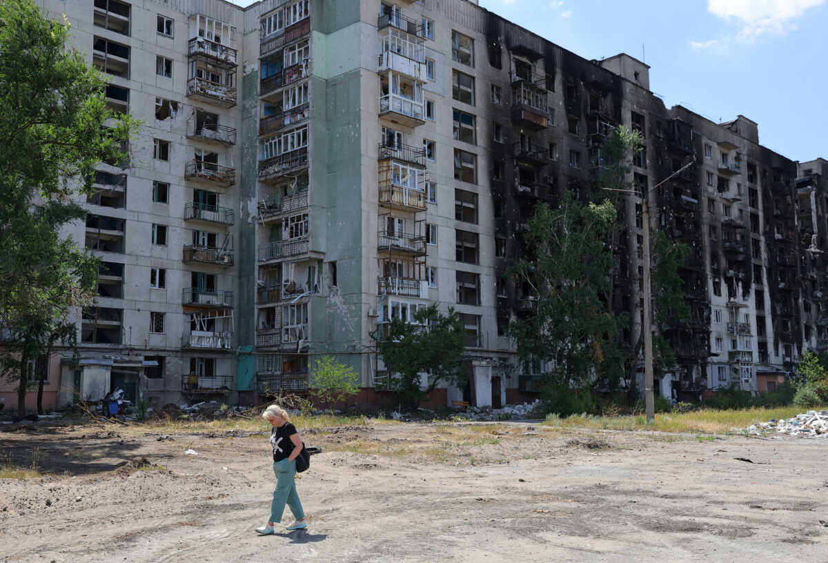 A local resident walks past an apartment building heavily damaged during Ukraine-Russia conflict in the city of Sievierodonetsk in the Luhansk Region, Ukraine July 1, 2022. REUTERS