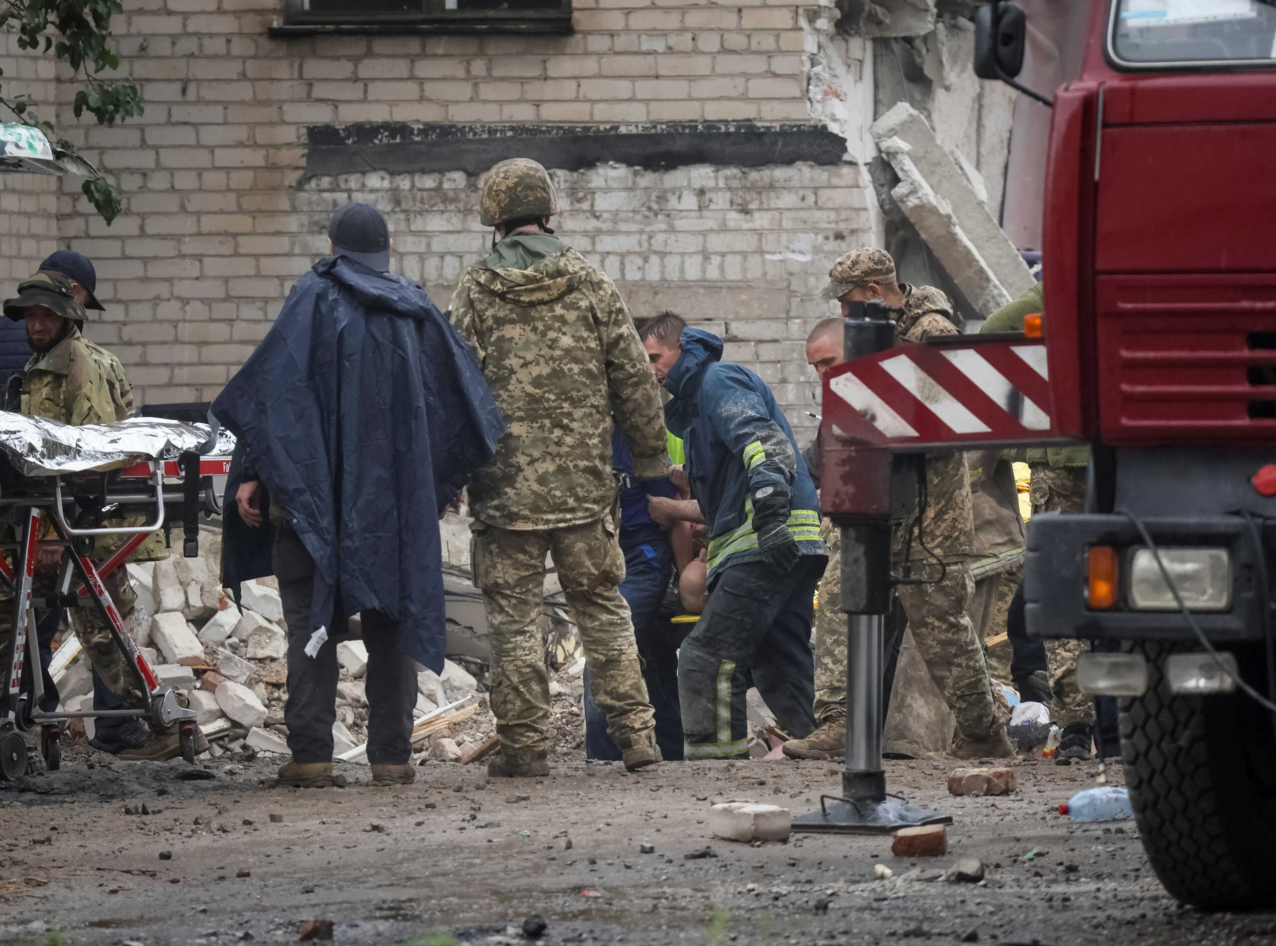 Rescuers extract a survivor from a residential building damaged by a Russian military strike, amid Russia's invasion on Ukraine, in the town of Chasiv Yar, in Donetsk region, Ukraine, July 11, 2022. REUTERS