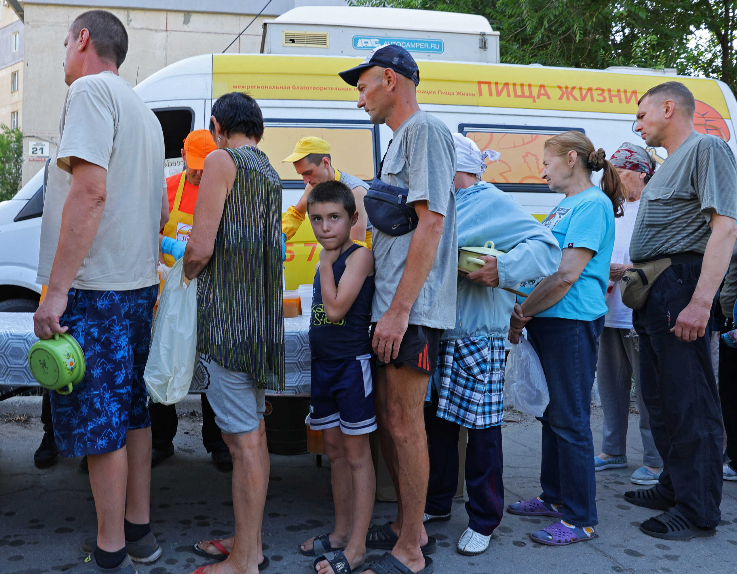 Local residents gather to receive food distributed by volunteers during Ukraine-Russia conflict in the city of Sievierodonetsk in the Luhansk Region, Ukraine June 30, 2022. REUTERS