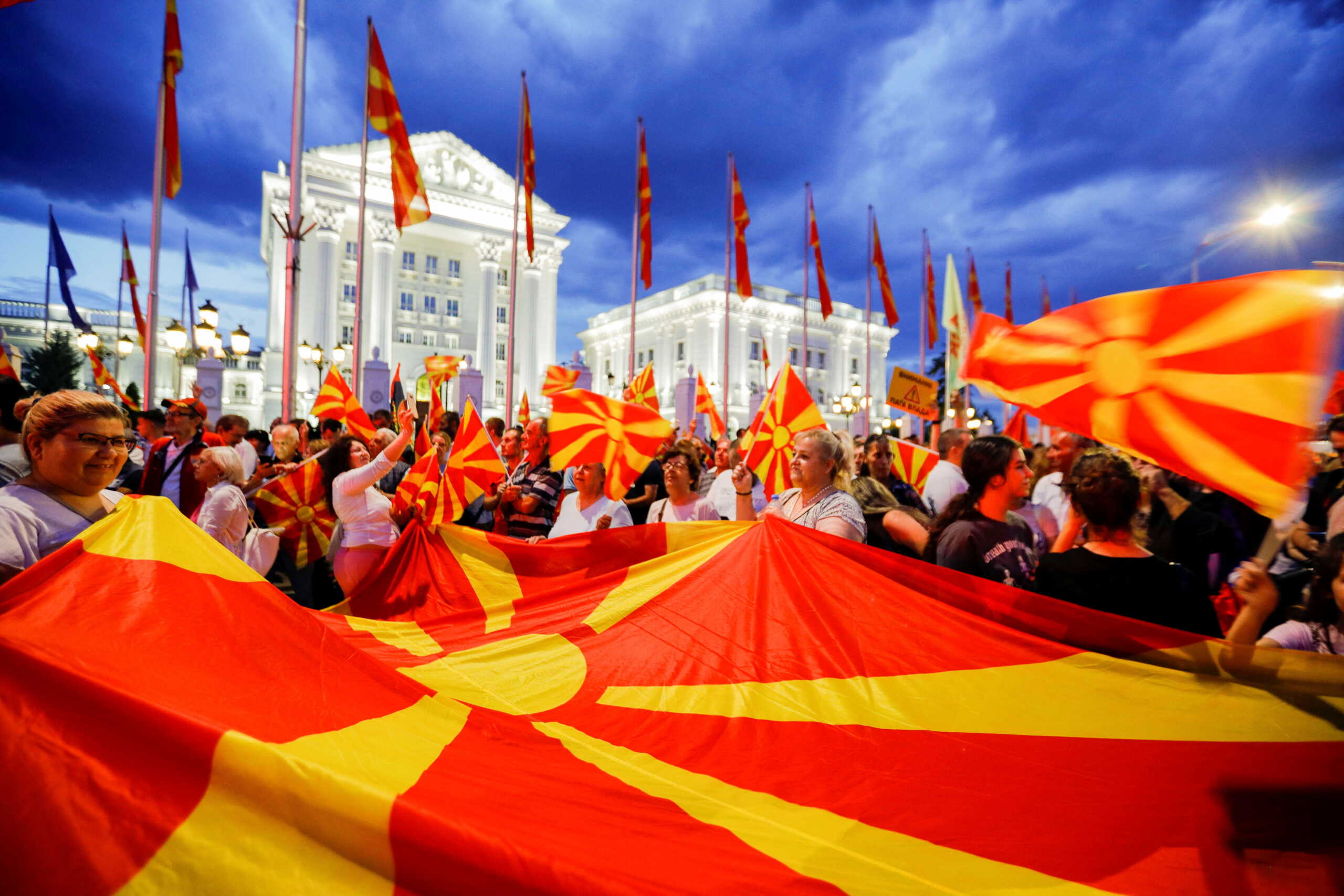Supporters of North Macedonia's biggest opposition party VMRO-DPMNE, wave flags and shout slogans during a rally demanding early elections, in Skopje, North Macedonia June 18, 2022. REUTERS