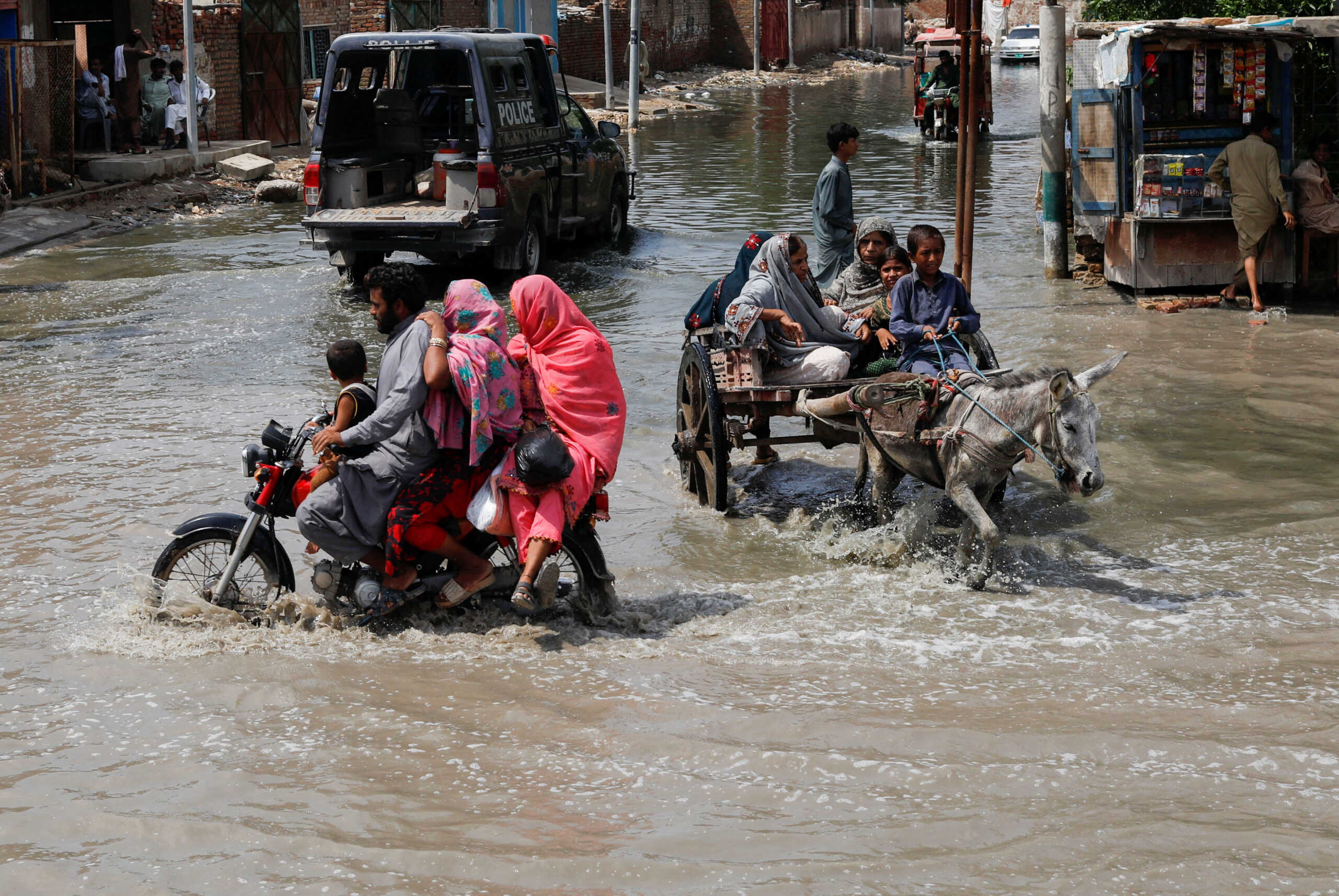 Commuters travel through rain waters, following rains and floods during the monsoon season in Jacobabad, Pakistan August 30, 2022. REUTERS