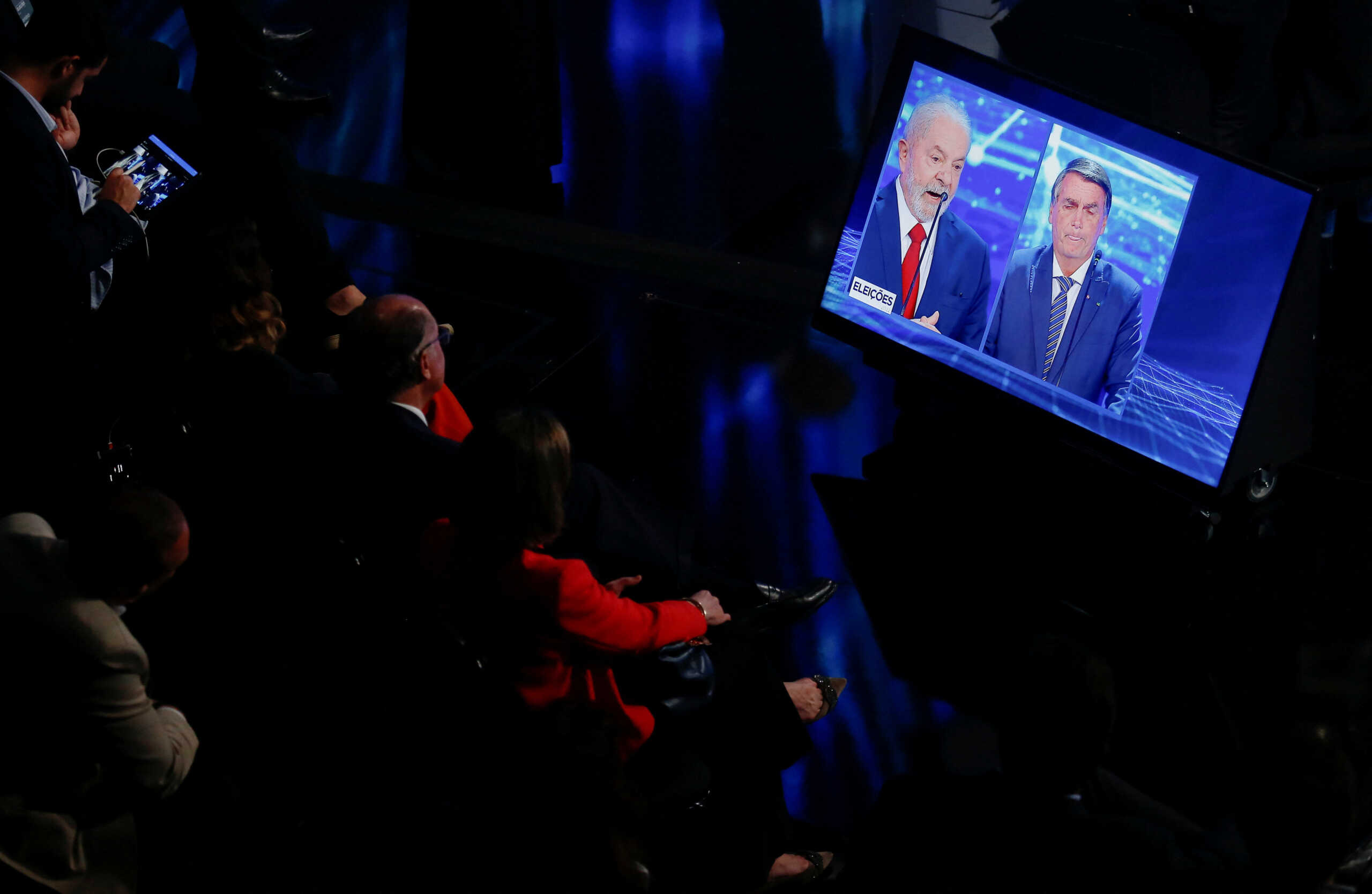 Brazil's President Jair Bolsonaro, presidential candidate of the Liberal Party (PL), and Brazil's former president Luiz Inacio Lula da Silva, presidential candidate of the Workers Party (PT), are shown on a screen as they participate in the first Presidential Debate ahead of the national election, in Sao Paulo, Brazil, August 28, 2022. REUTERS
