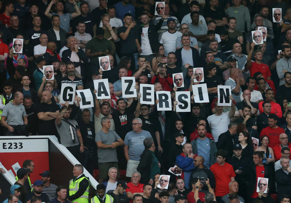 Soccer Football - Premier League - Manchester United v Liverpool - Old Trafford, Manchester, Britain - August 22, 2022 Liverpool fans hold up signs inside the stadium before the match REUTERS