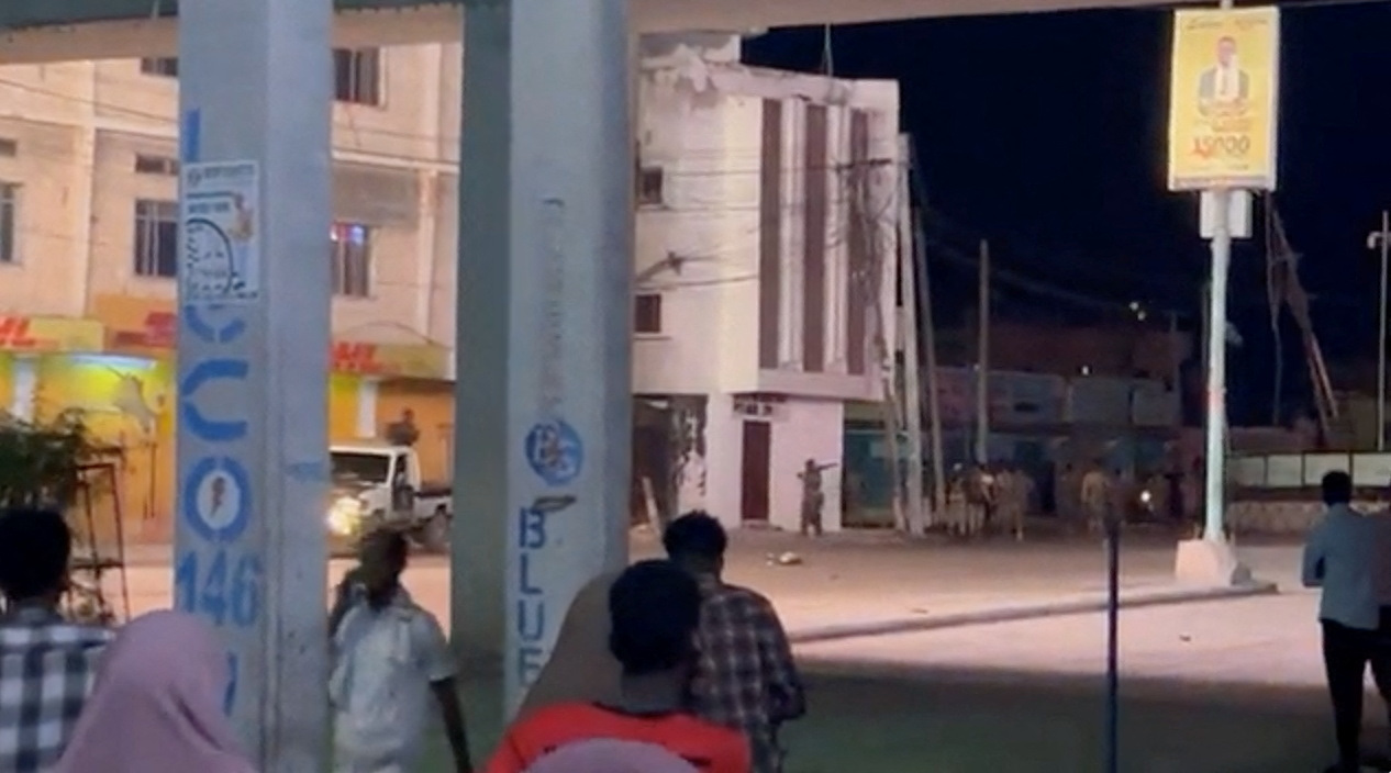 Members of the security forces take position after, according to police and intelligence officers, unidentified armed attackers took control of a hotel, in Mogadishu, Somalia, August 19, 2022 in this screen grab from a video obtained from social media. Abdalle Ahmed Mumin