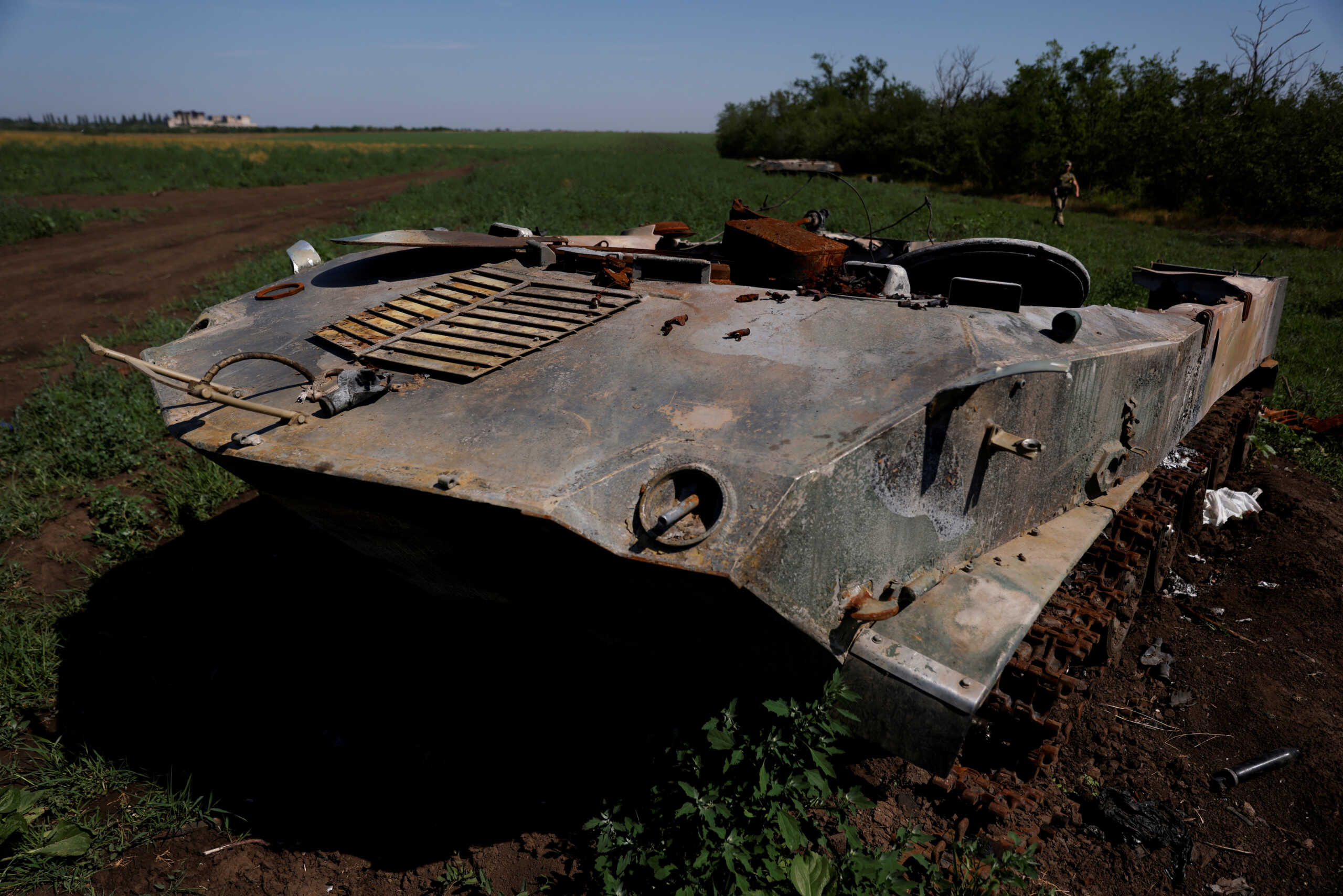FILE PHOTO: A Ukrainian soldier walks past destroyed Russian tanks in a field, as Russia's attacks on Ukraine continue, in Mykolaiv region, Ukraine June 12, 2022. REUTERS