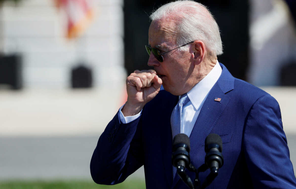 U.S. President Joe Biden coughs during a signing event for the CHIPS and Science Act of 2022, on the South Lawn of the White House in Washington, U.S., August 9, 2022. REUTERS
