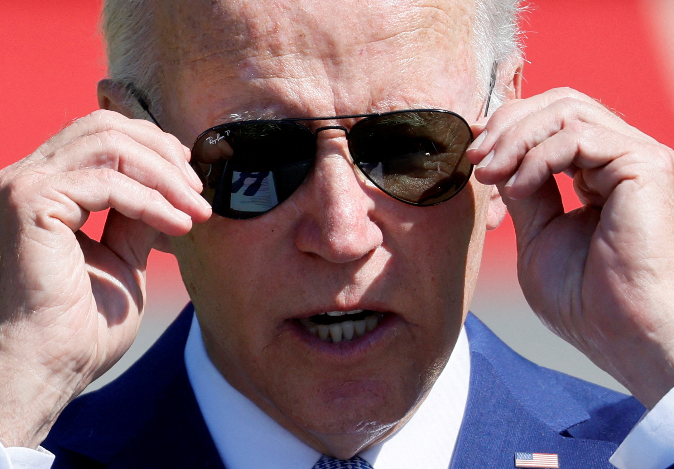 U.S. President Joe Biden adjusts his glasses as he delivers remarks during a signing event for the CHIPS and Science Act of 2022, on the South Lawn of the White House in Washington, U.S., August 9, 2022. REUTERS