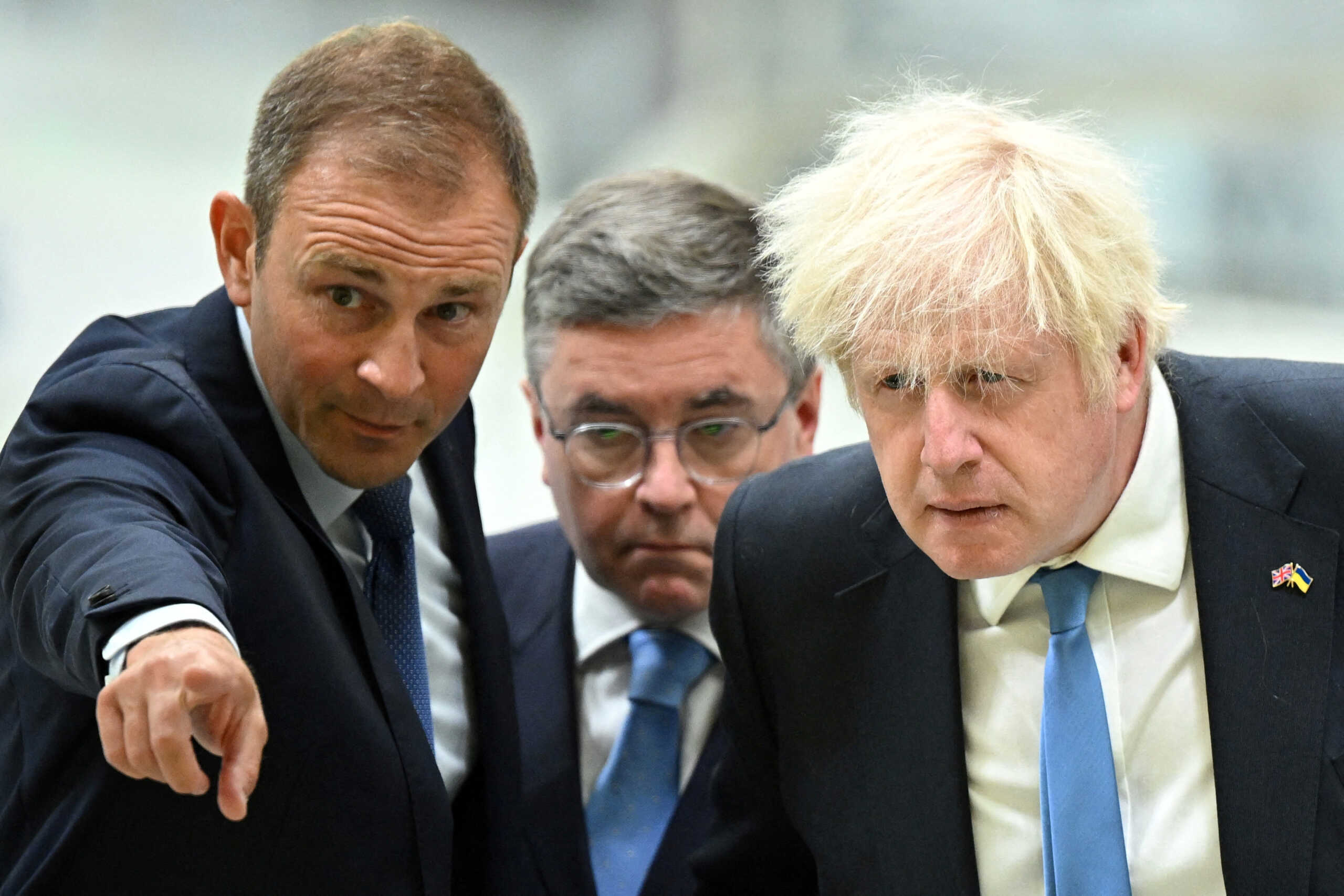 Britain's Prime Minister Boris Johnson listens to Head of Broughton plant at Airbus Jerome Blandin (L), next to Secretary of State for Wales Robert Buckland, during a visit of the division manufacturing the wings for the A350 as part of a tour of the Broughton Airbus plant, in Chester, Britain, August 12, 2022. Oli Scarff