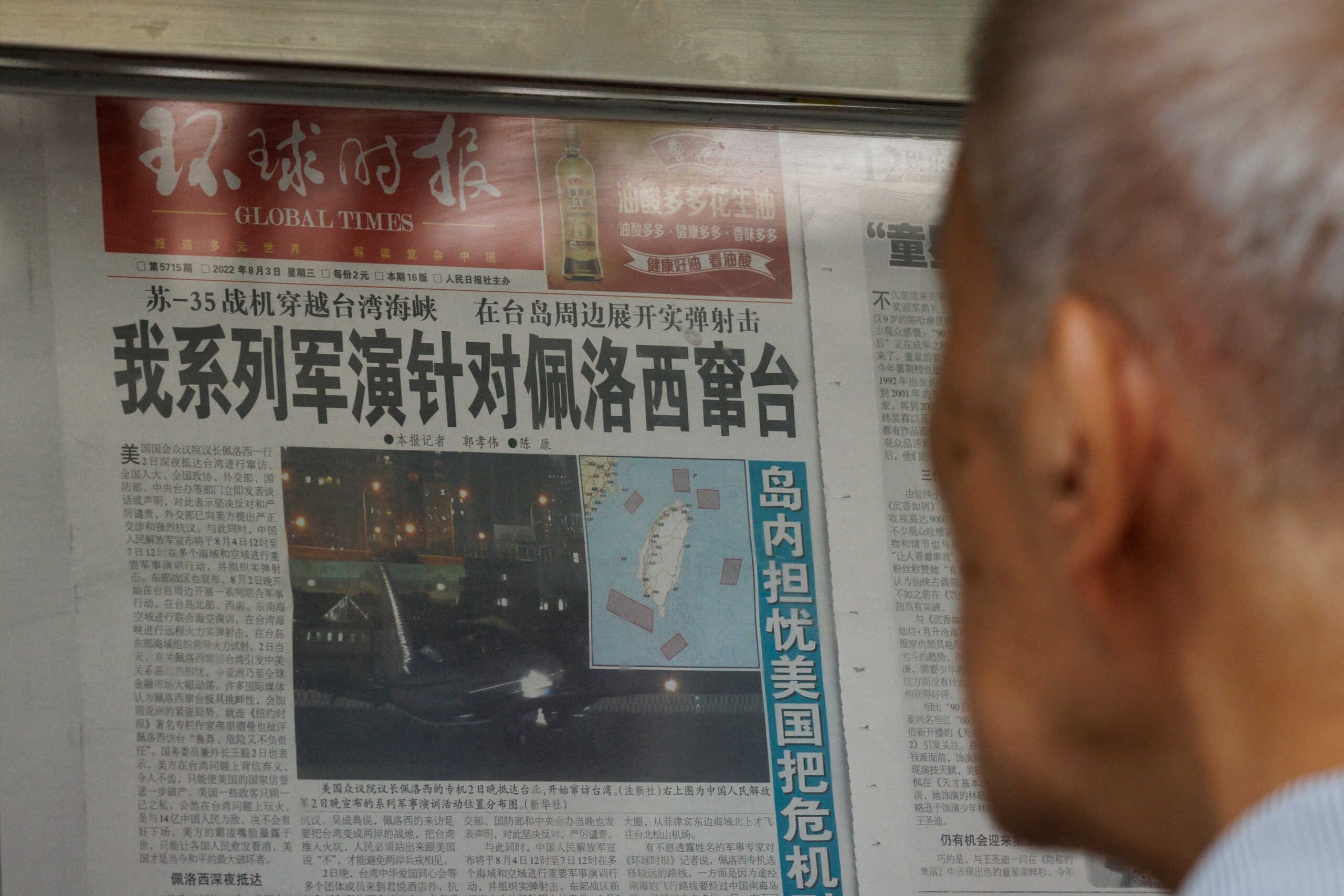A man reads a Global Times article about military exercises by the Chinese People's Liberation Army (PLA) following U.S. House of Representatives Speaker Nancy Pelosi's Taiwan visit, at a newspaper stand in Beijing, China, August 4, 2022.   REUTERS