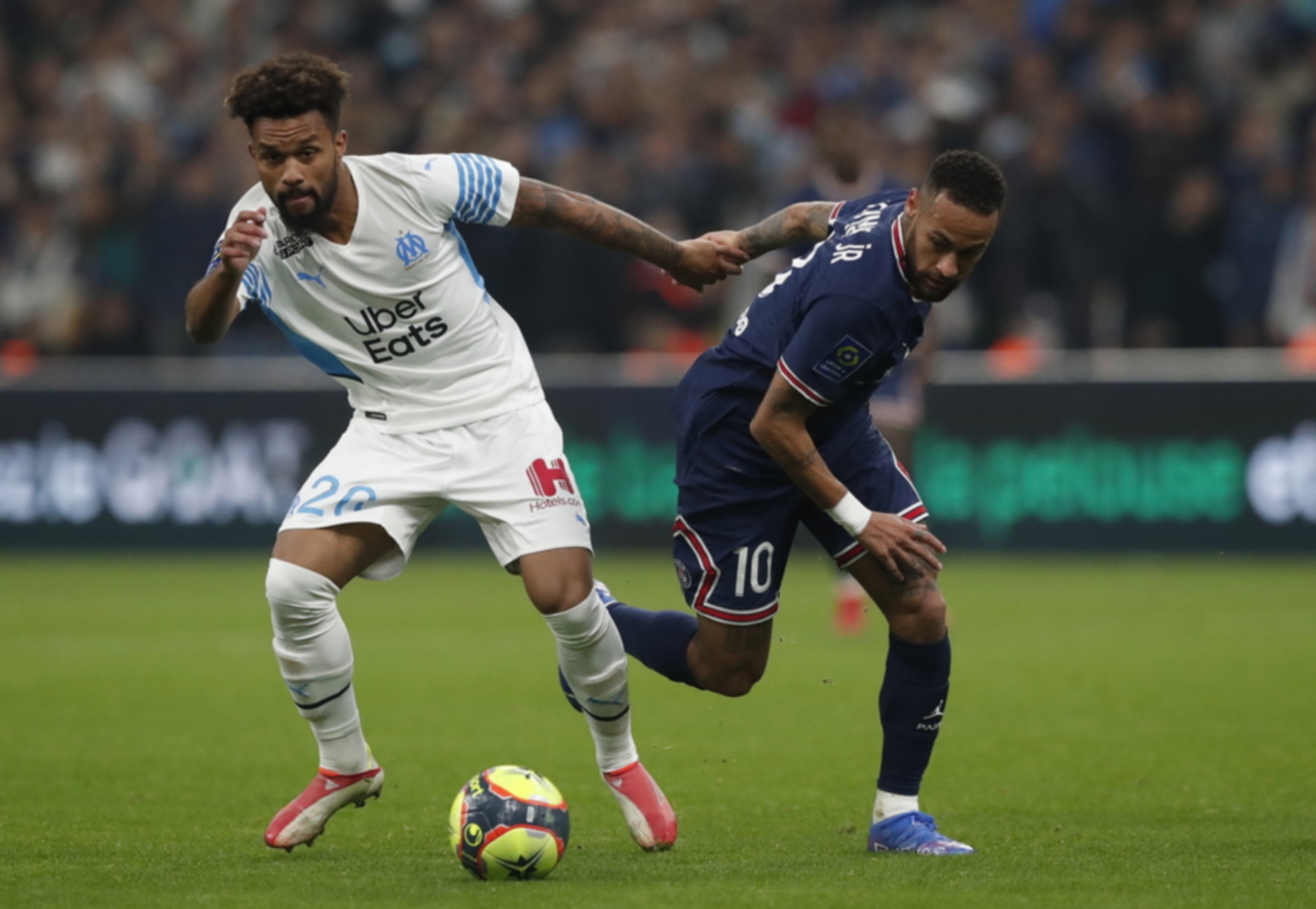 epa09544477 Konrad De La Fuente (L) of Olympique Marseille and Neymar (R) of Paris Saint Germain in action during the French Ligue 1 soccer match between Olympique Marseille and Paris Saint Germain at the Velodrome Stadium in Marseille, southern France, 24 October 2021.  EPA