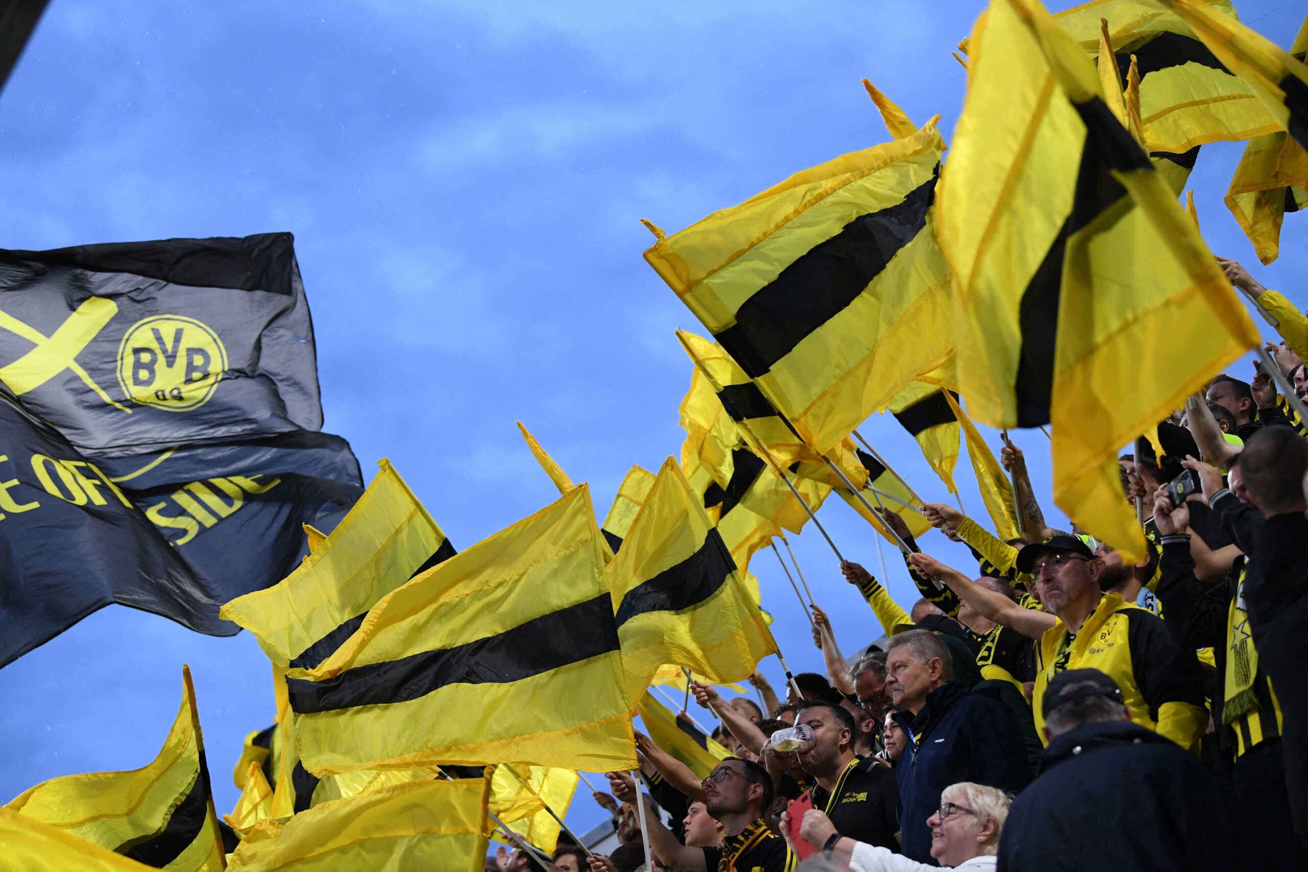 Soccer Football - DFB Cup - First Round - TSV 1860 Munich v Borussia Dortmund - Grunwalder Stadion, Munich, Germany - July 29, 2022 Borussia Dortmund fans with flags inside the stadium before the match REUTERS