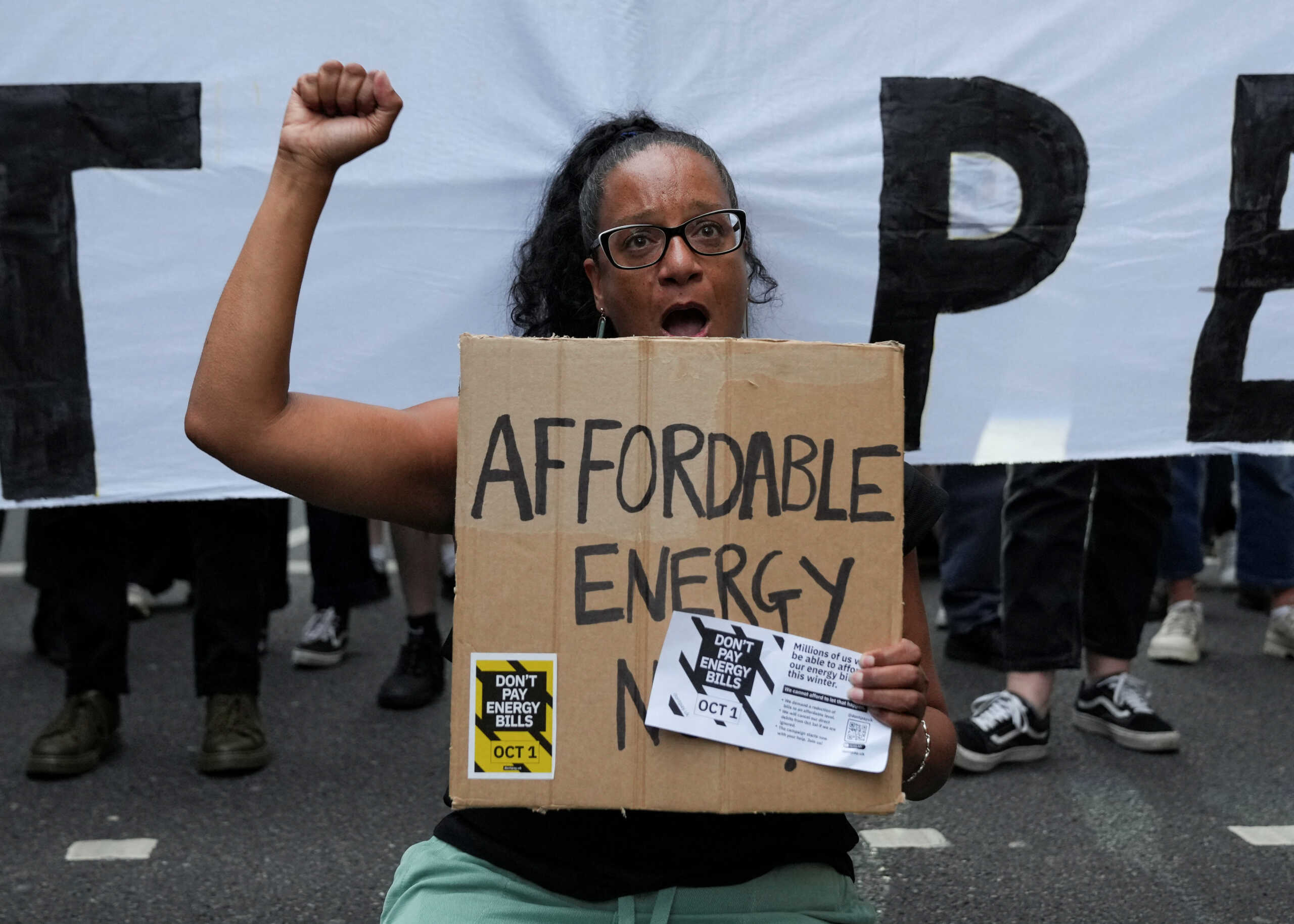 Demonstrators block a street in Canary Wharf during a protest outside the Ofgem headquarters, following the energy price cap announcement, in London, Britain, August 26, 2022. REUTERS