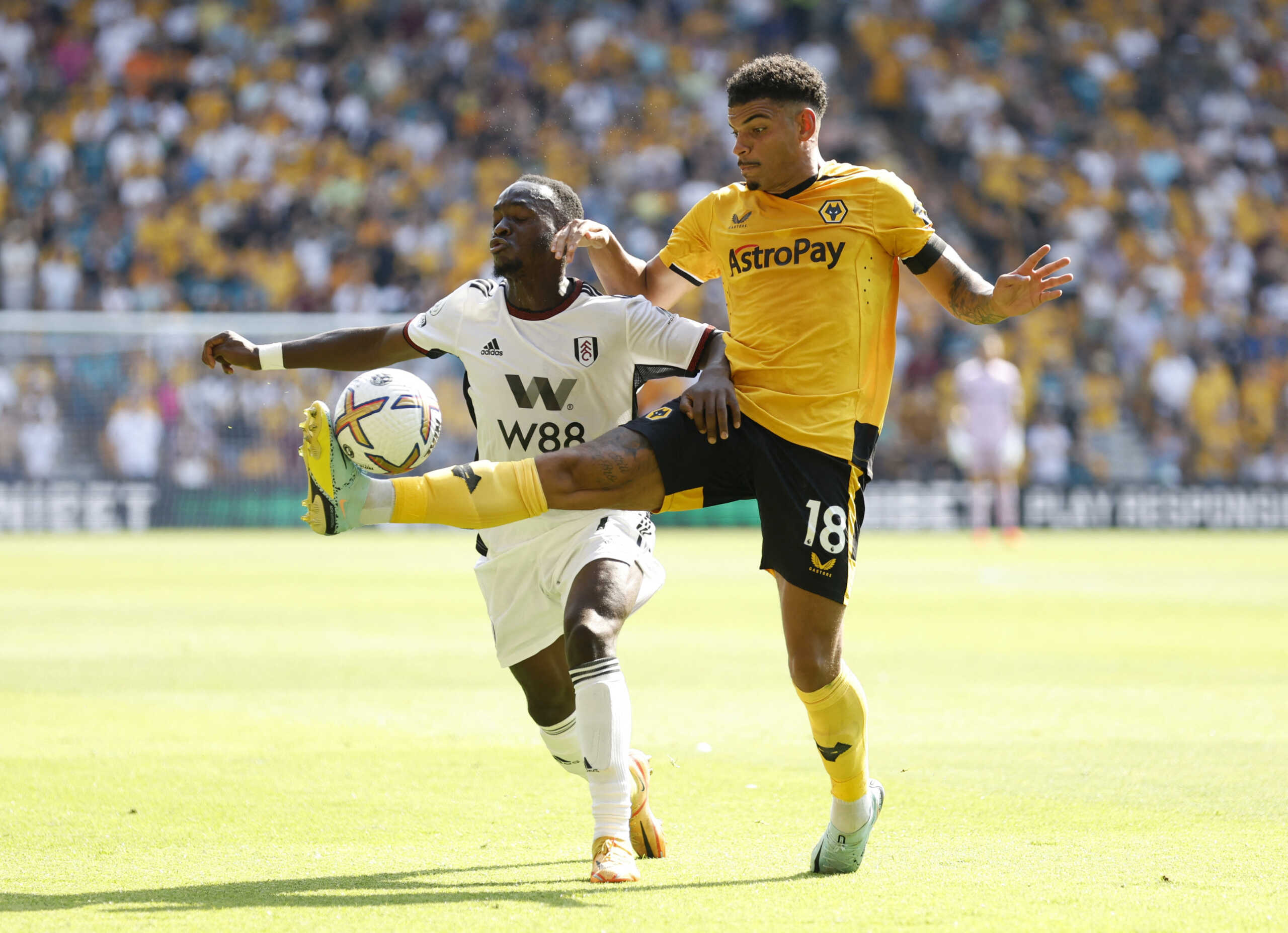 Soccer Football - Premier League - Wolverhampton Wanderers v Fulham - Molineux Stadium, Wolverhampton, Britain - August 13, 2022  Wolverhampton Wanderers' Morgan Gibbs-White in action with Fulham's Neeskens Kebano Action Images via Reuters