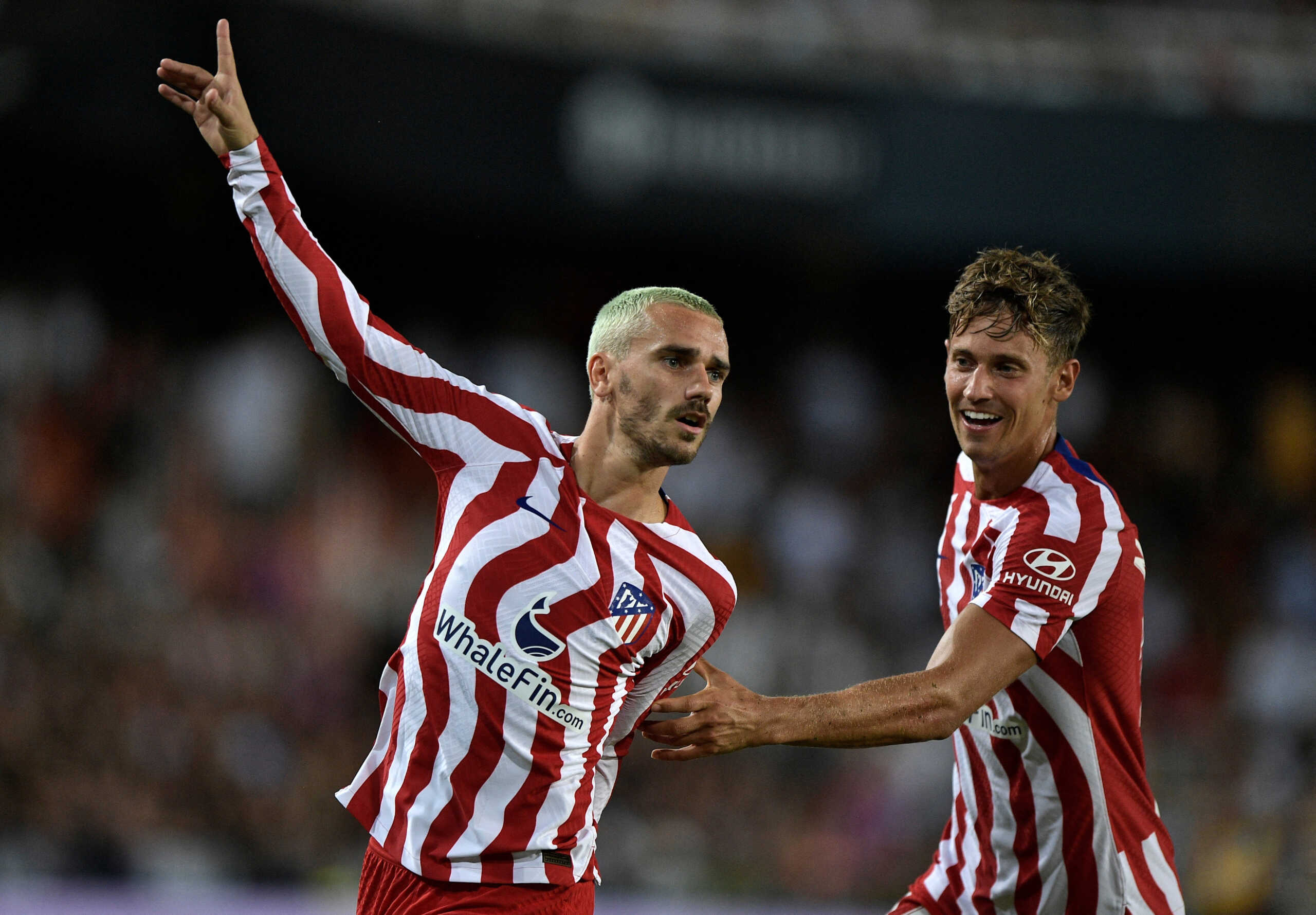 Soccer Football - LaLiga - Valencia v Atletico Madrid - Mestalla, Valencia, Spain - August 29, 2022 Atletico Madrid's Antoine Griezmann celebrates scoring their first goal with Marcos Llorente REUTERS