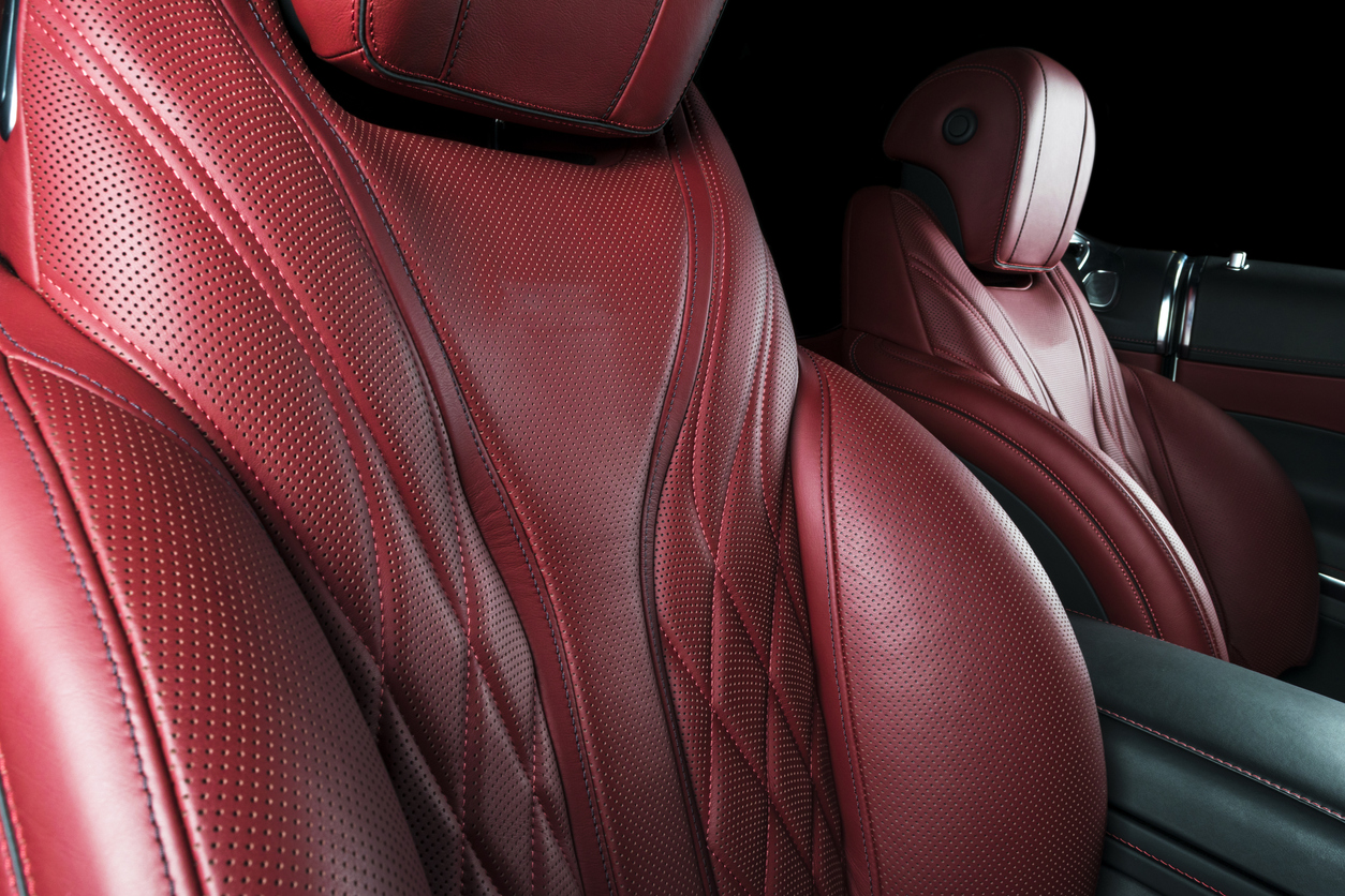 Car inside. Interior of a car. Comfortable leather Red seats. Red perforated leather. Car interior details. Car detailing