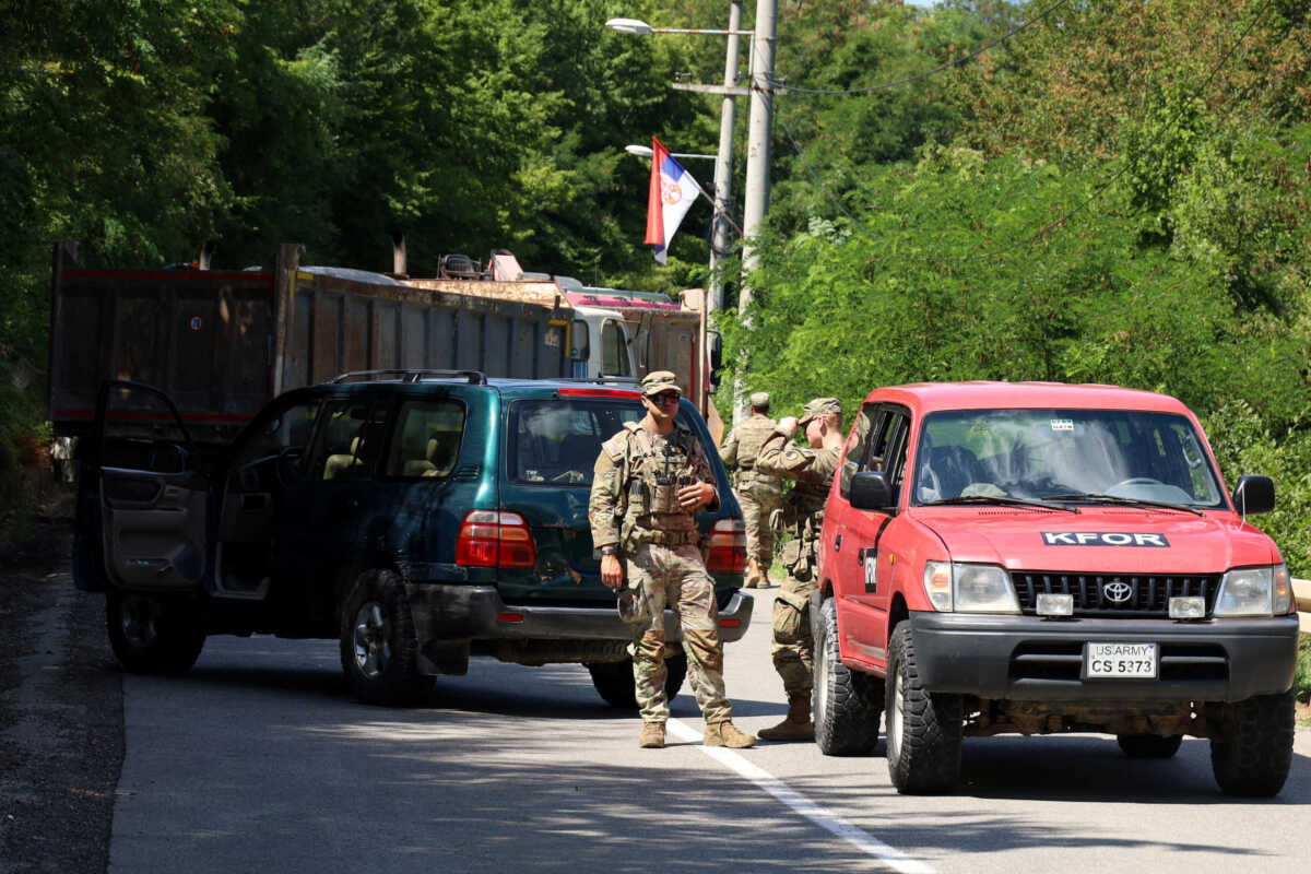 U.S. troops part of KFOR are seen as trucks block a road in Zupce, Kosovo August 1, 2022. REUTERS