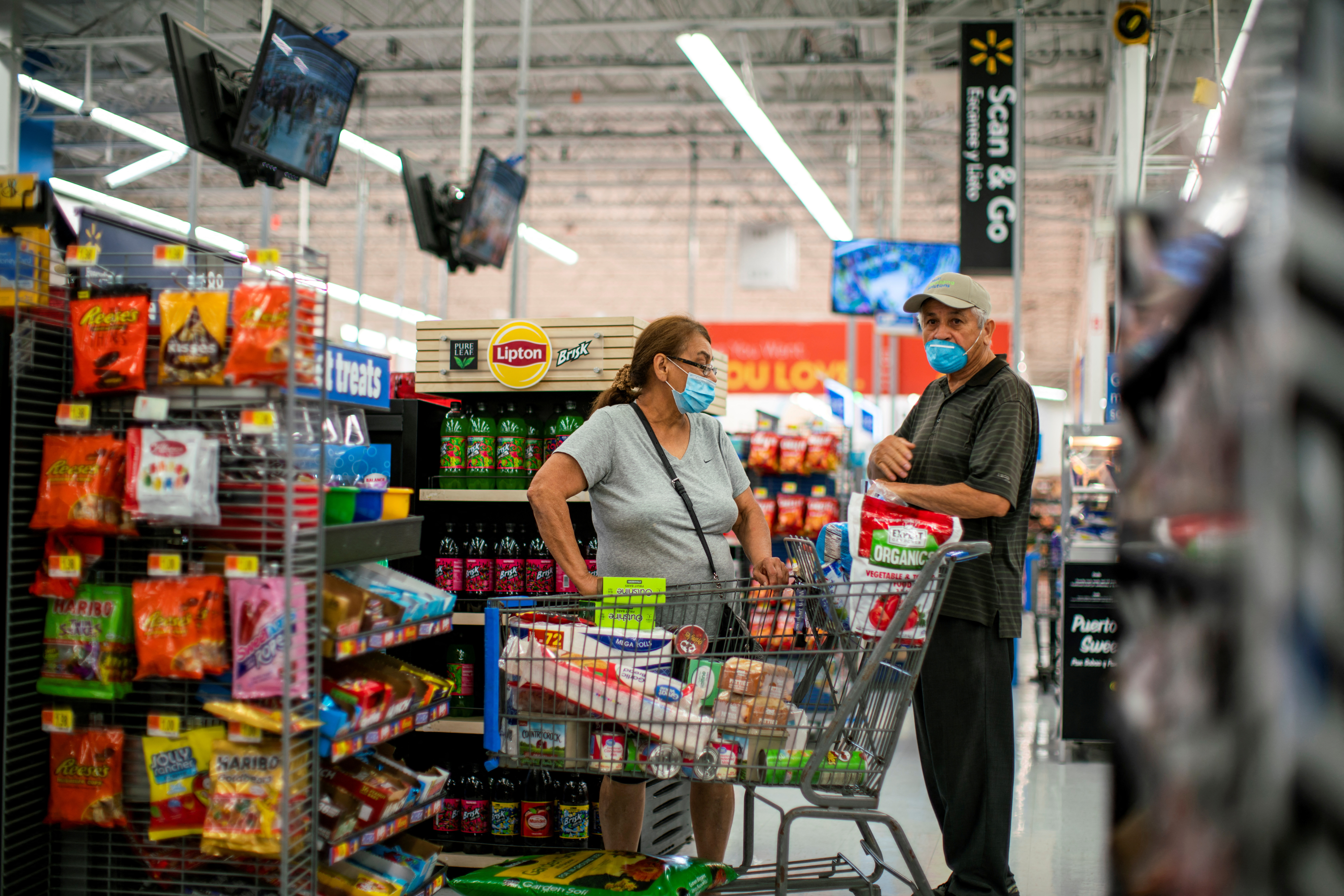 FILE PHOTO: Shoppers are seen wearing masks while shopping at a Walmart store, in North Brunswick, New Jersey, U.S. July 20, 2020. REUTERS