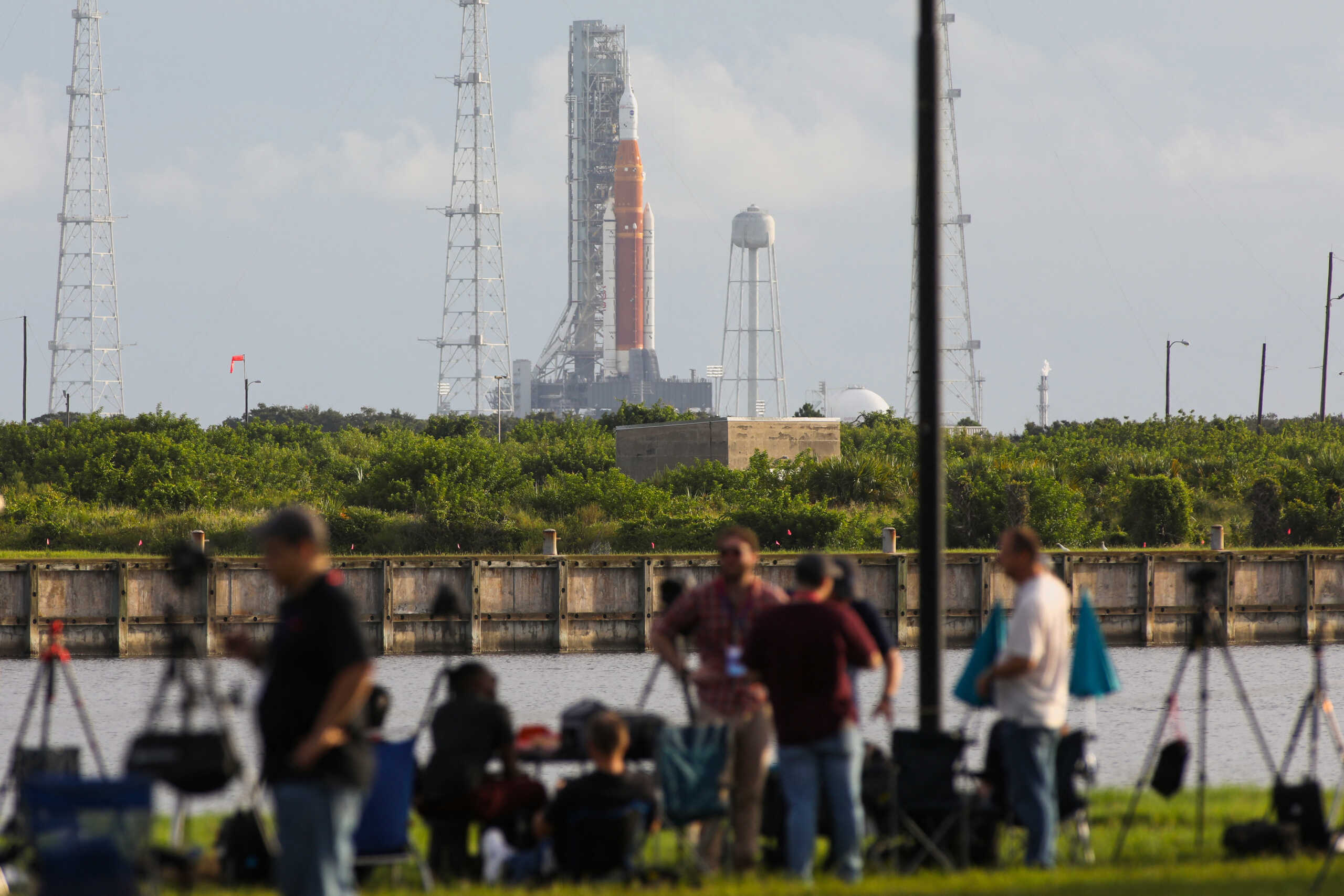 News media members react as NASA's next-generation moon rocket, the Space Launch System (SLS) , with its Orion crew capsule on top, sits on the pad after the launch of the Artemis I mission was scrubbed, at Cape Canaveral, Florida, U.S., August 29, 2022. REUTERS