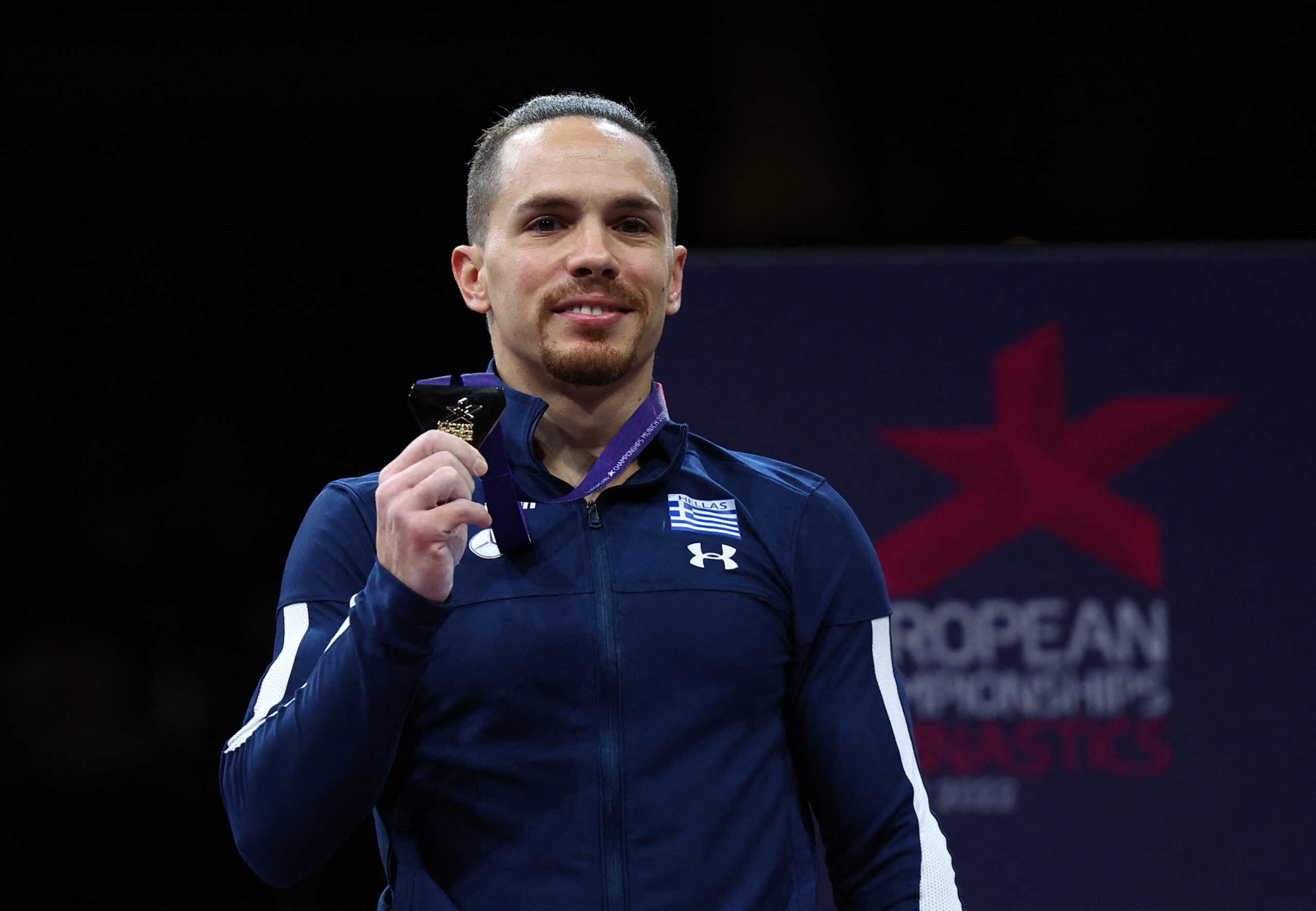 2022 European Championships - Artistic Gymnastics - Olympiahalle, Munich, Germany - August 21, 2022 Gold medallist Greece's Aleftherios Petrounias celebrates on the podium after winning the Men's Rings Final REUTERS