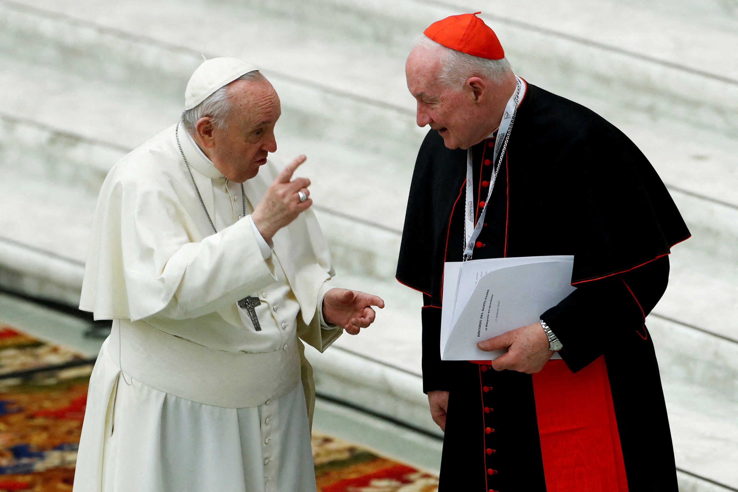FILE PHOTO: Pope Francis talks to Cardinal Marc Ouellet of Canada as he inaugurates the work of the International Symposium "For a fundamental theology of the priesthood" at the Vatican, February 17, 2022. REUTERS