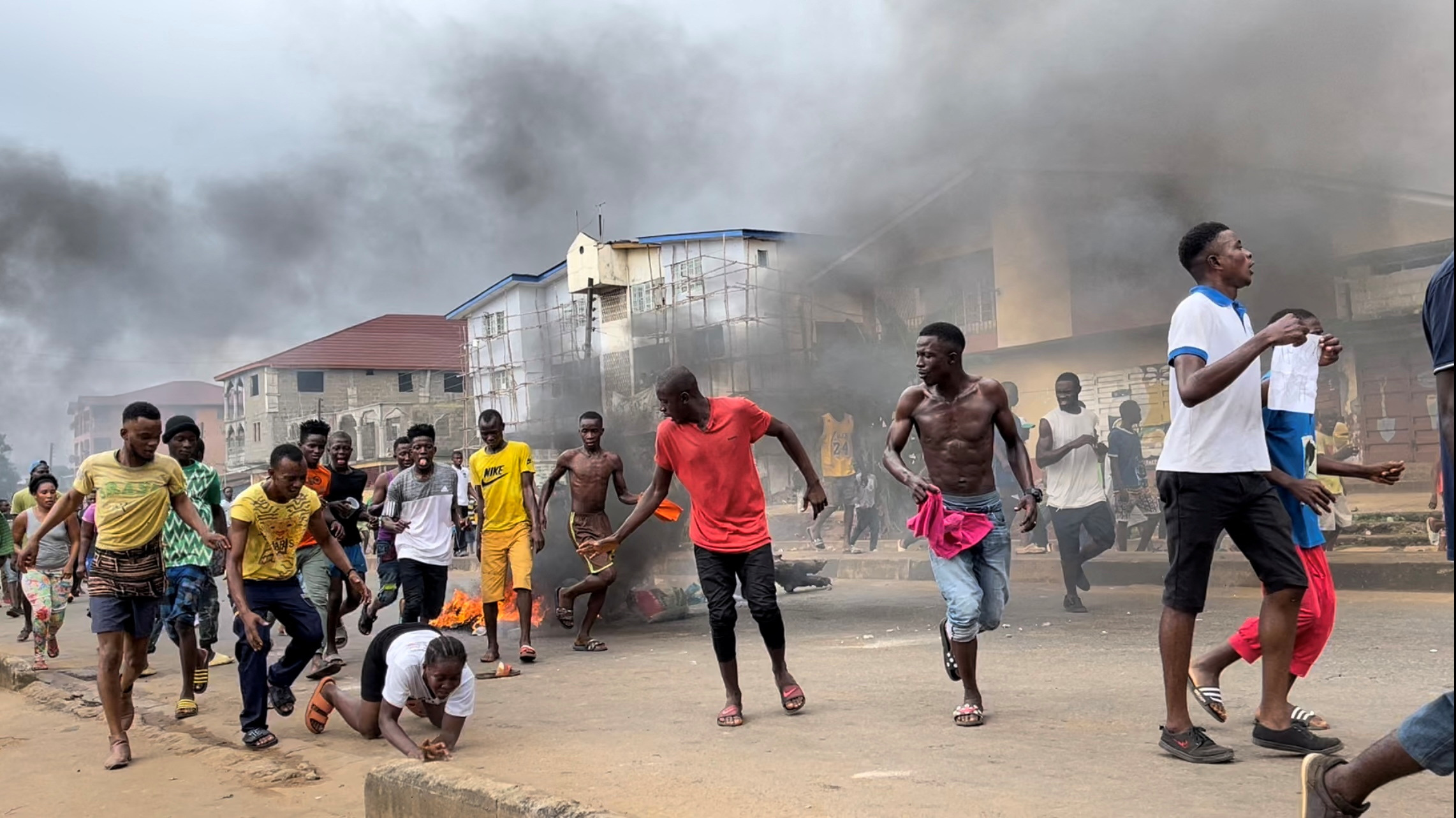 People run away during an anti-government protest, in Freetown, Sierra Leone, August 10, 2022 in this picture obtained from social media. Picture obtained by Reuters