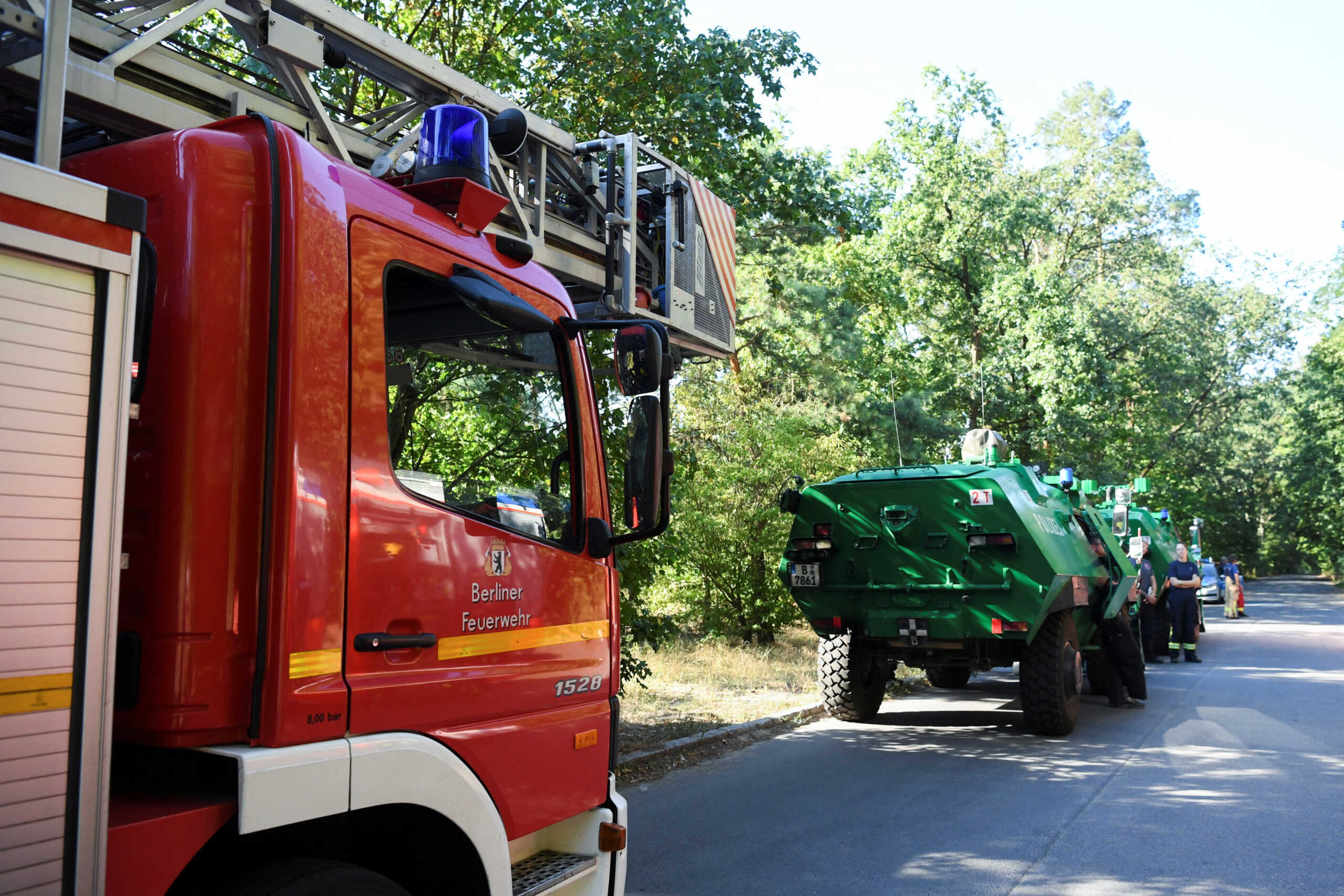Firefighter vehicles are seen near the closed motorway access Huettenweg, due to an explosion in munitions depot in the Grunewald forest in Berlin, Germany August 4, 2022. REUTERS