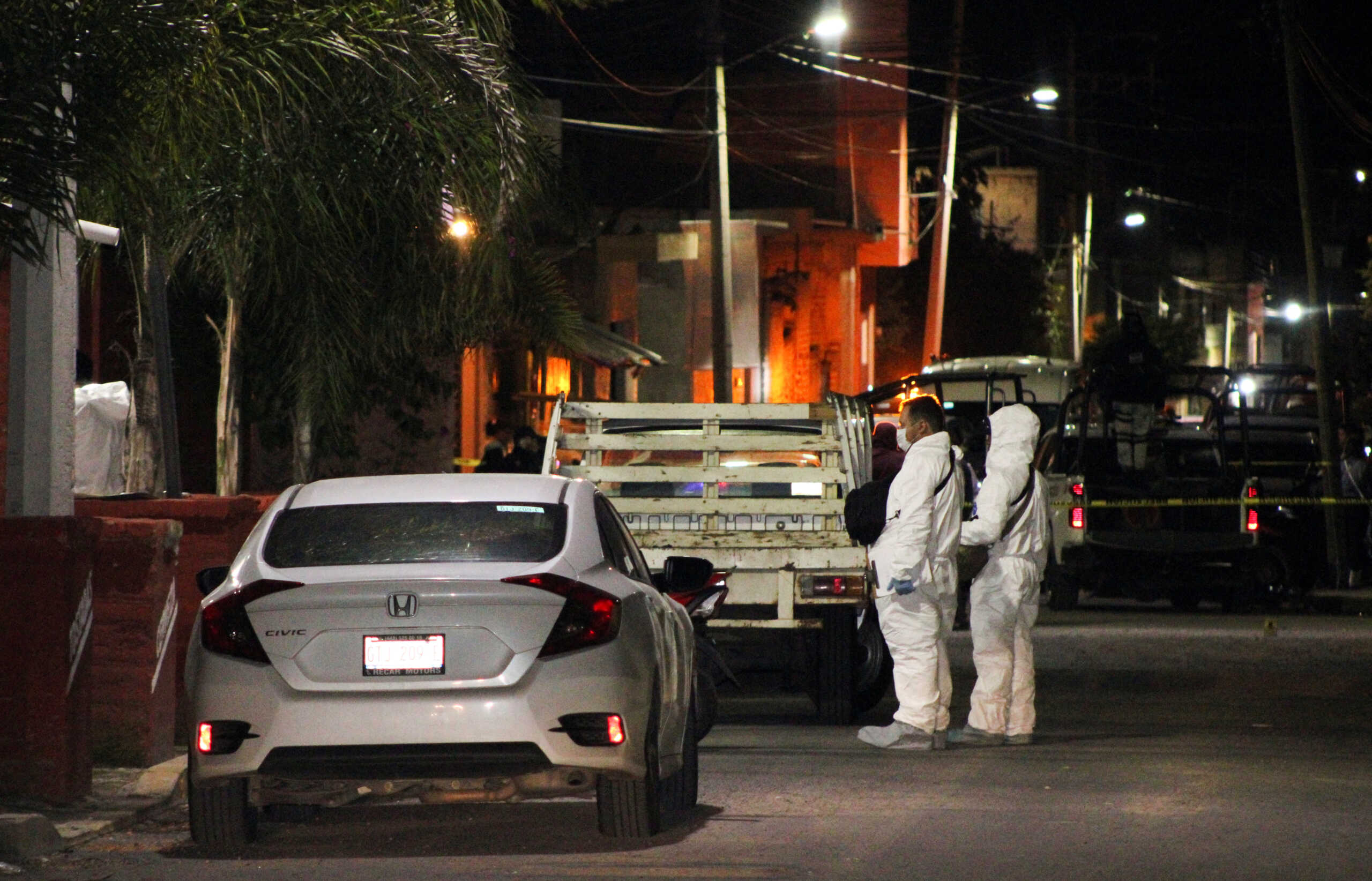 Forensic officers stand outside a bar where unidentified gunmen opened fire killing several people, officials said, in the latest outbreak of violence, in Tarimoro, Guanajuato state, Mexico September 21, 2022. REUTERS
