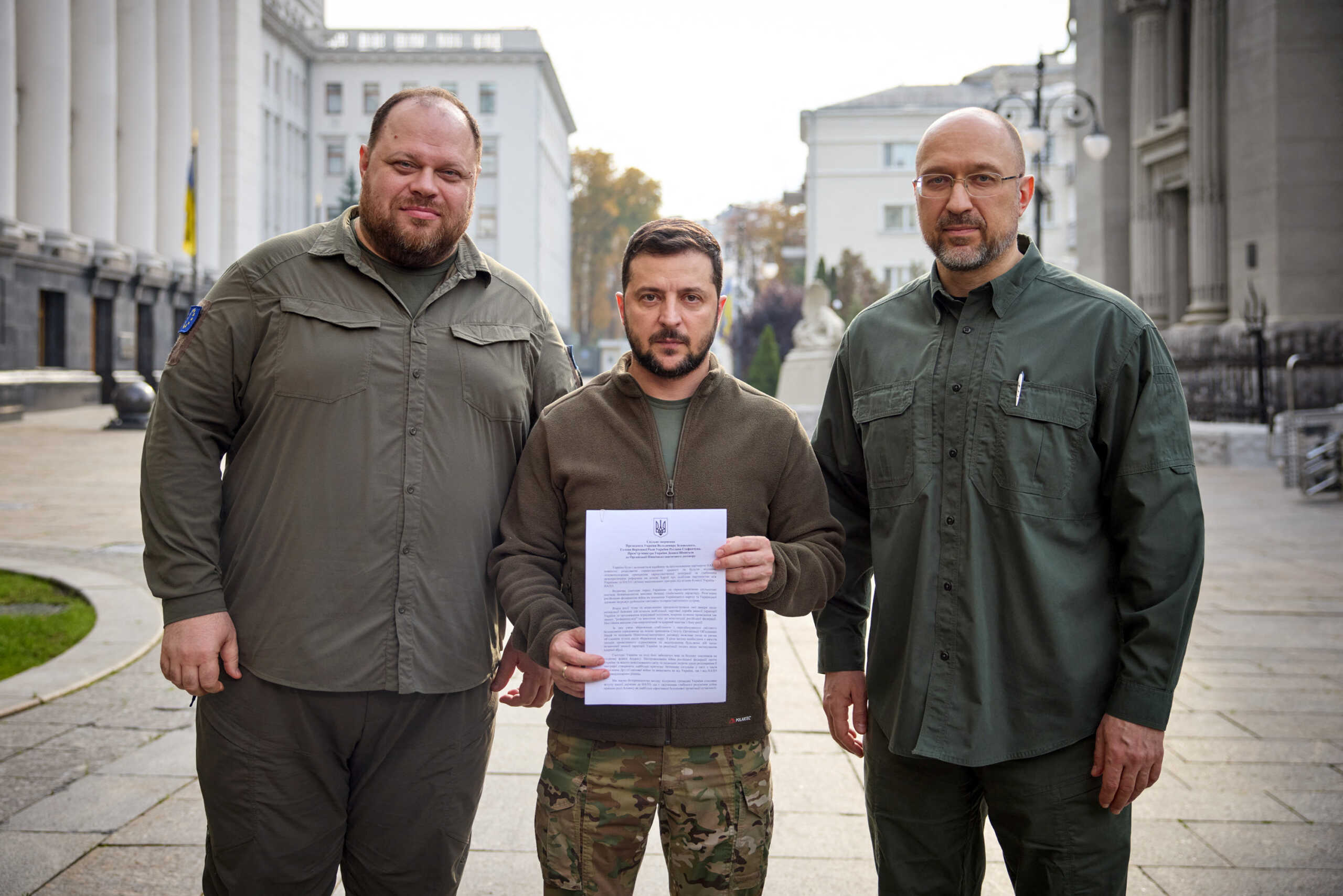 Ukraine's President Volodymyr Zelenskiy, Prime Minister Denys Shmyhal and Parliament Speaker Ruslan Stefanchuk pose with a request for fast-track membership in the NATO military alliance, amid Russia's attack on Ukraine, after Russia held what it called referendums – votes that were denounced by Kyiv and Western governments as illegal and coercive – in Kyiv, Ukraine September 30, 2022.  Ukrainian Presidential Press Service