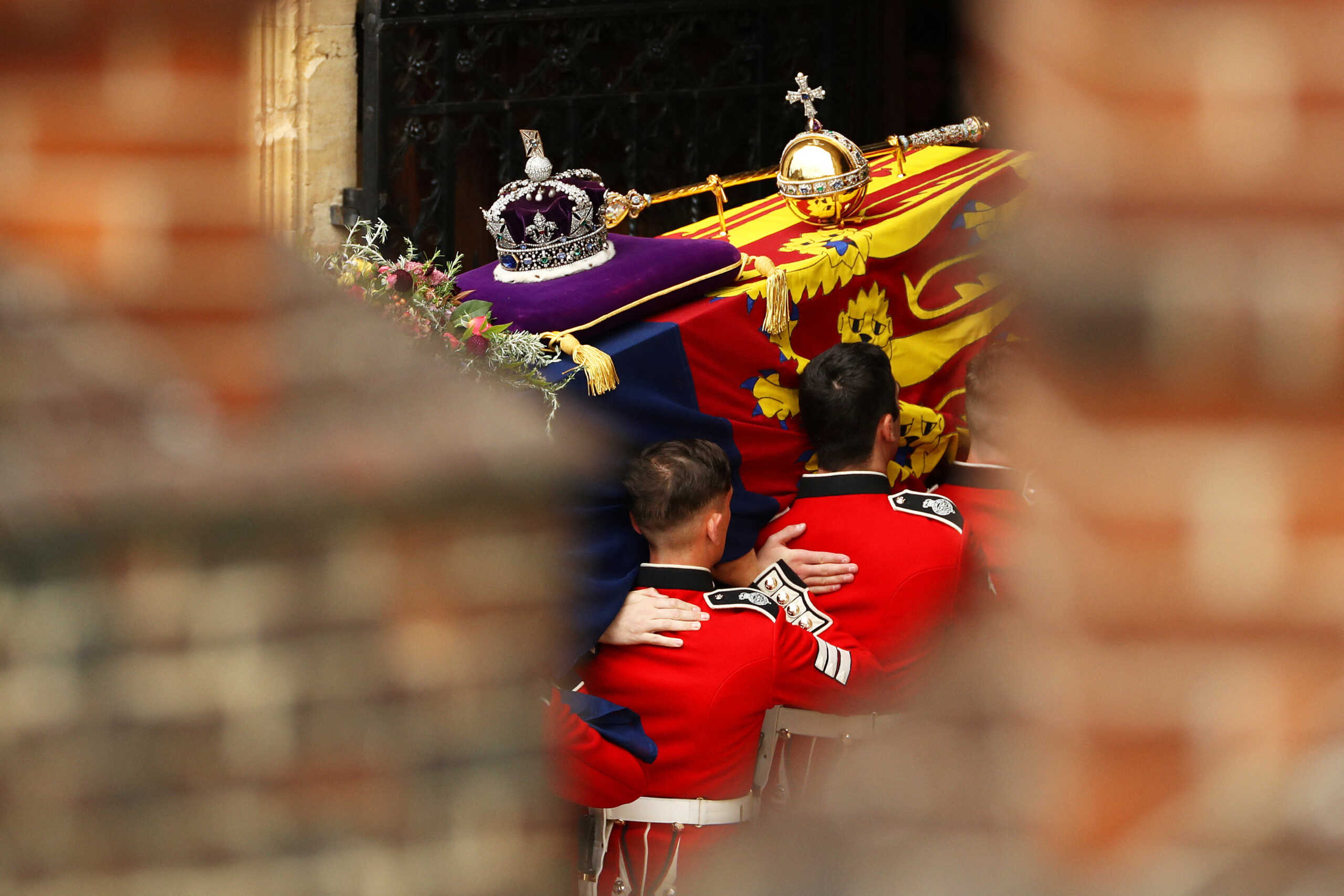 WINDSOR, ENGLAND - SEPTEMBER 19: Pall bearers carry the coffin of Queen Elizabeth II with the Imperial State Crown resting on top into St. George's Chapel on September 19, 2022 in Windsor, England. The committal service at St George's Chapel, Windsor Castle, took place following the state funeral at Westminster Abbey. A private burial in The King George VI Memorial Chapel followed. Queen Elizabeth II died at Balmoral Castle in Scotland on September 8, 2022, and is succeeded by her eldest son, King Charles III.     Ryan Pierse