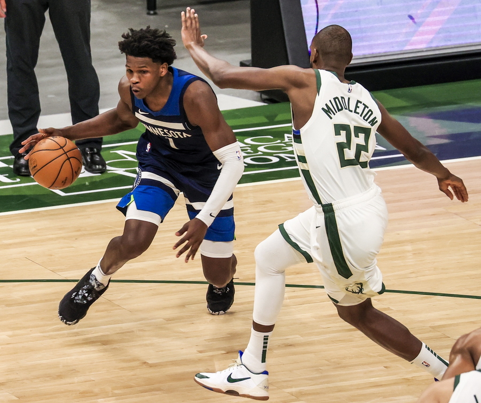 epa09032945 Minnesota Timberwolves forward Anthony Edwards (L) drives on Milwaukee Bucks forward Khris Middleton (R) during the NBA basketball game between the Minnesota Timberwolves and the Milwaukee Bucks at Fiserv Forum in Milwaukee, Wisconsin, USA, 23 February 2021.  EPA